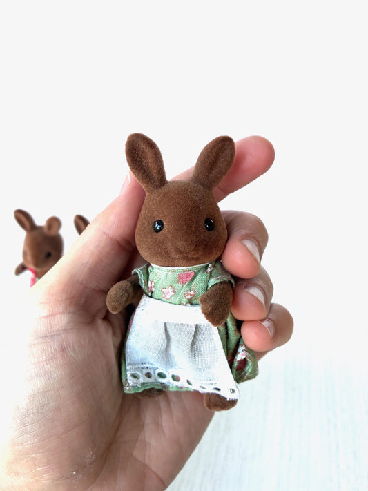 Vintage Sylvanian Families Wildwood Rabbit mother Ginger in green floral dress with white apron, Calico Critters brown rabbit held in hand