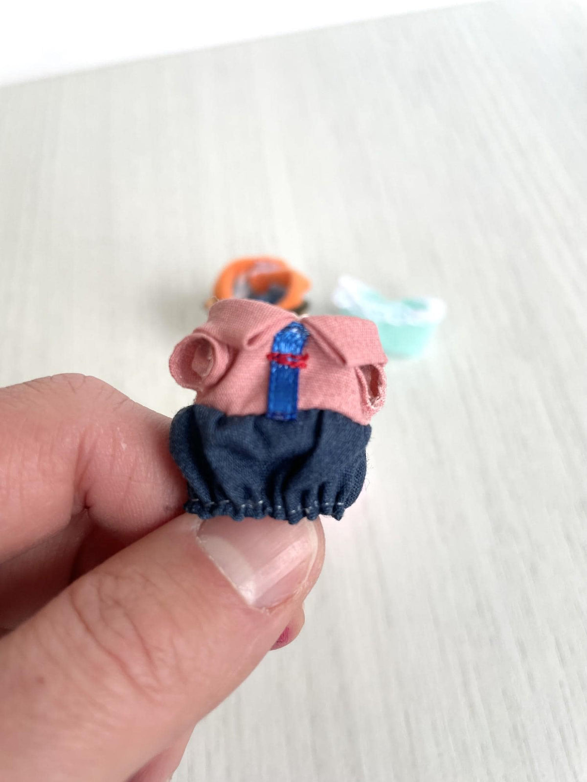 Calico Critters and Sylvanian Families spare baby outfit, pink top with navy denim bloomers held for detail