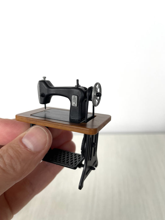 Front view of the treadle sewing machine showing the spoked wheel — Calico Critters and Sylvanian Families