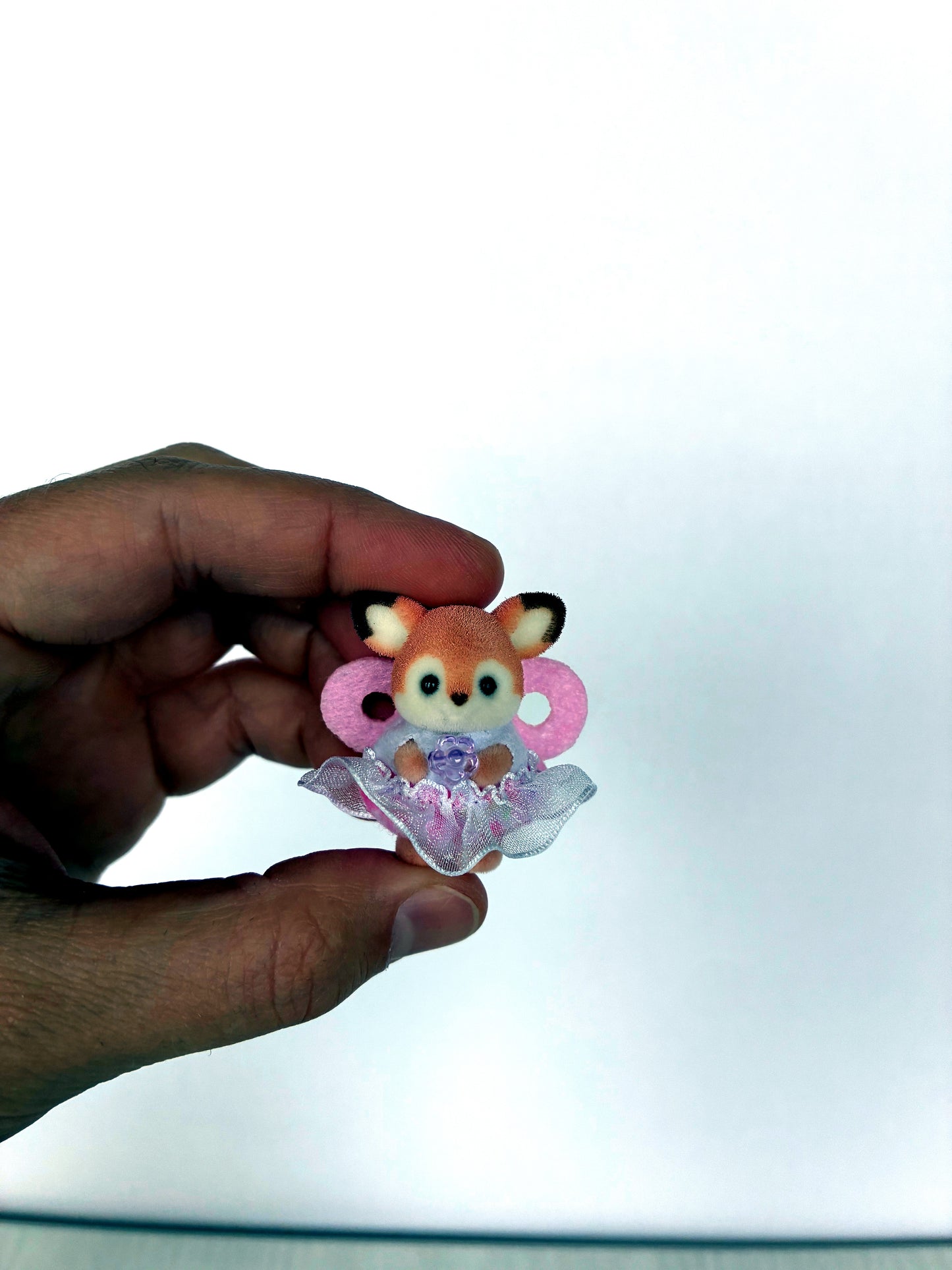 Deer fawn baby fairy figure held in hand for scale