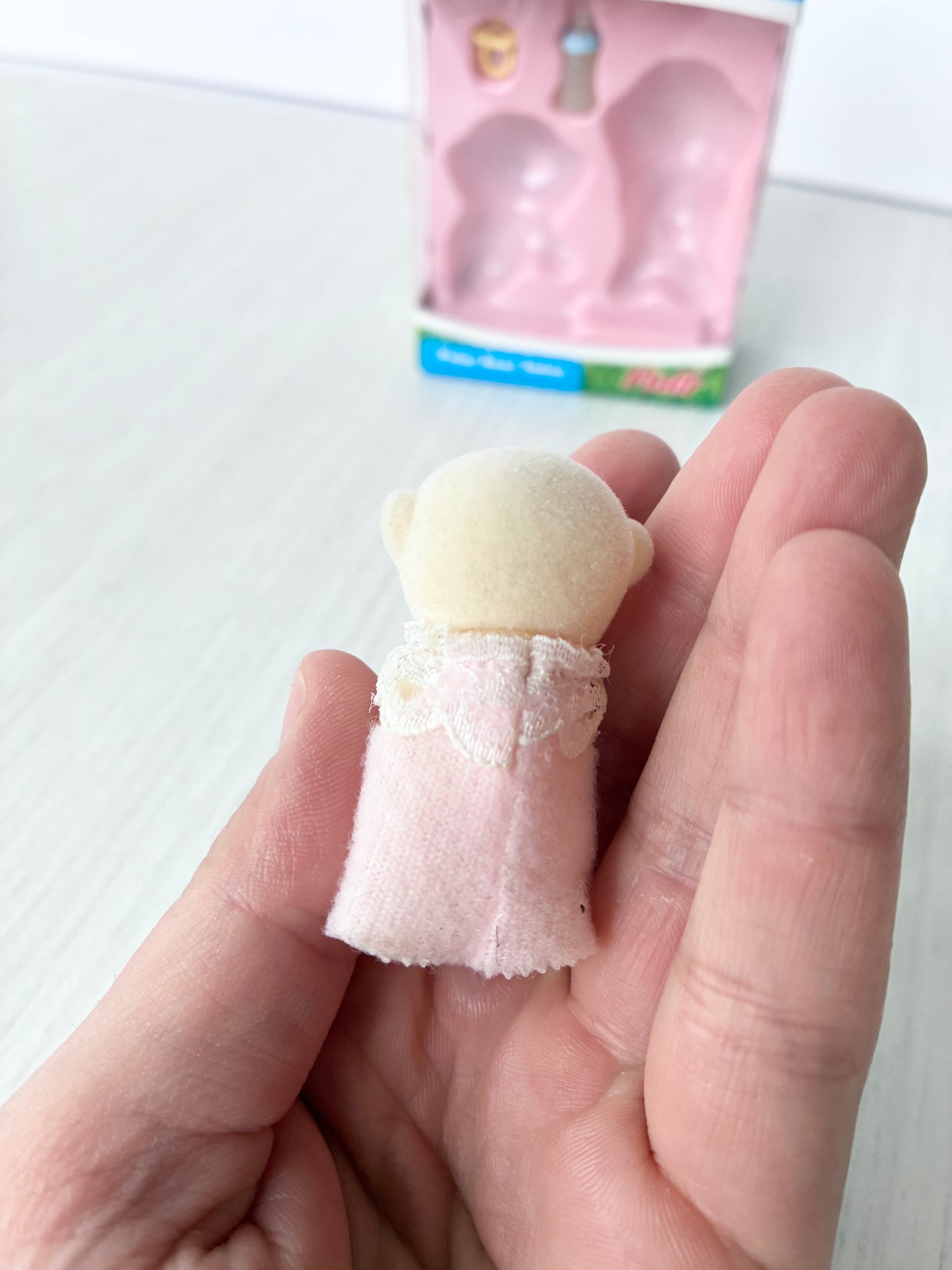 Calico Critters Sylvanian Families polar bear baby held in hand