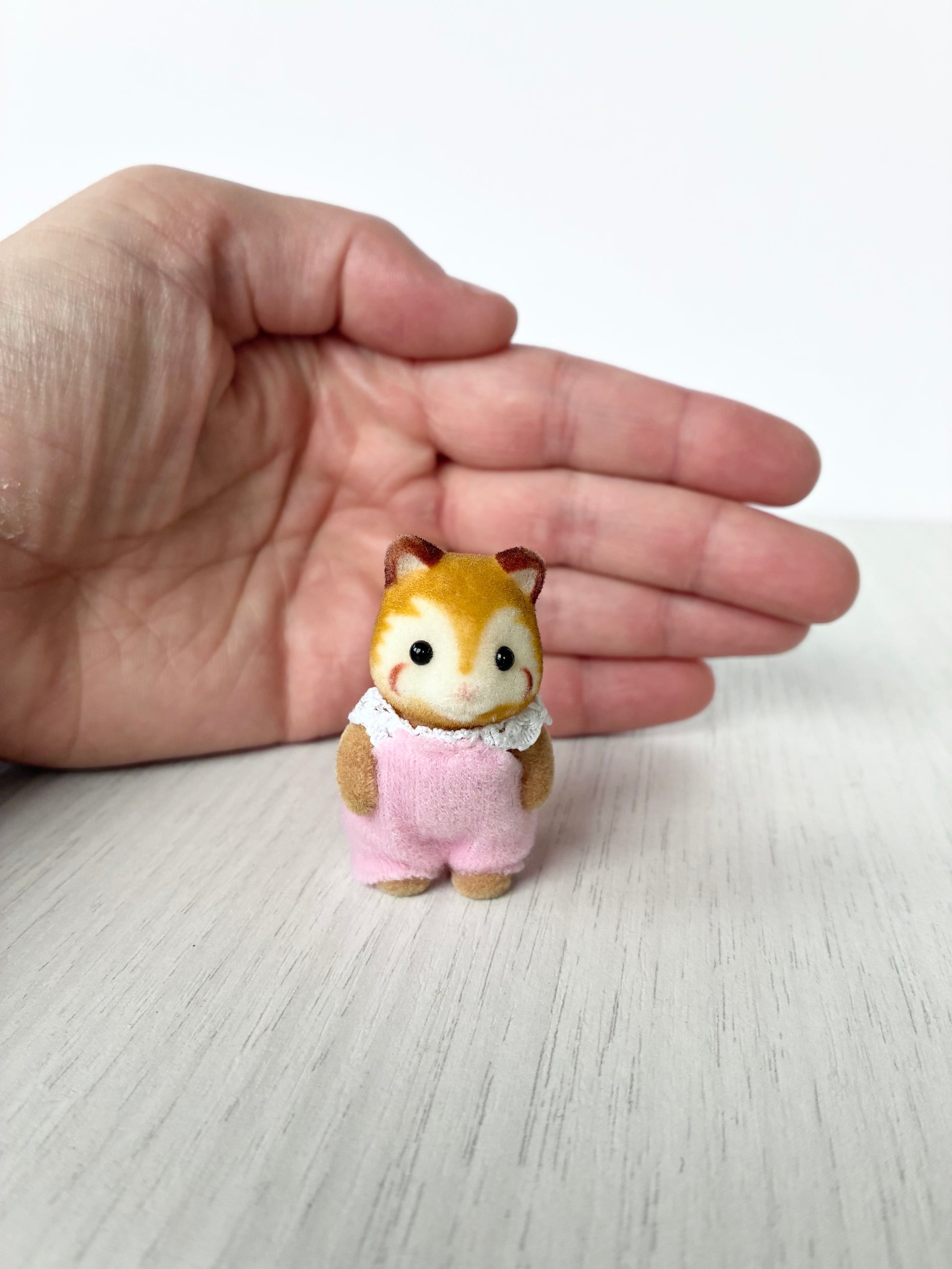 Calico Critters Sylvanian Families Buckley red panda baby standing in pink romper