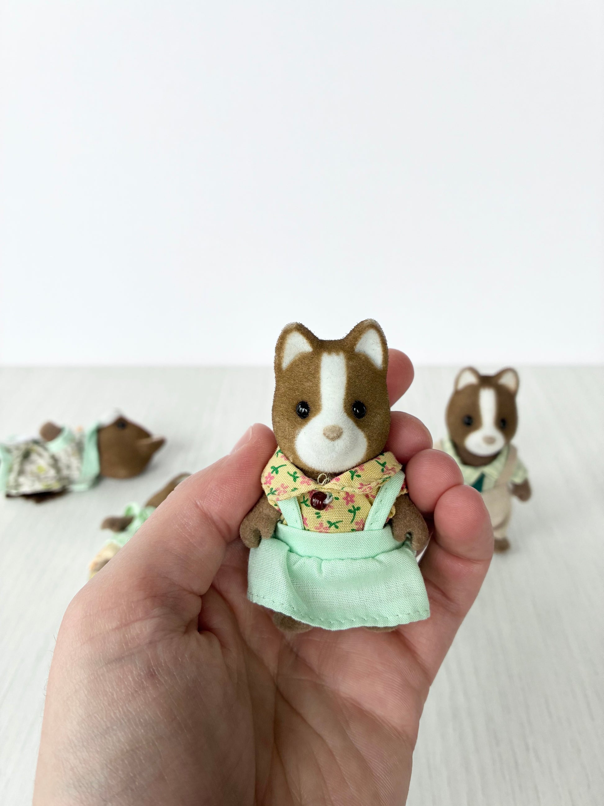 Calico Critters Sylvanian Families hound dog mother figure held in hand