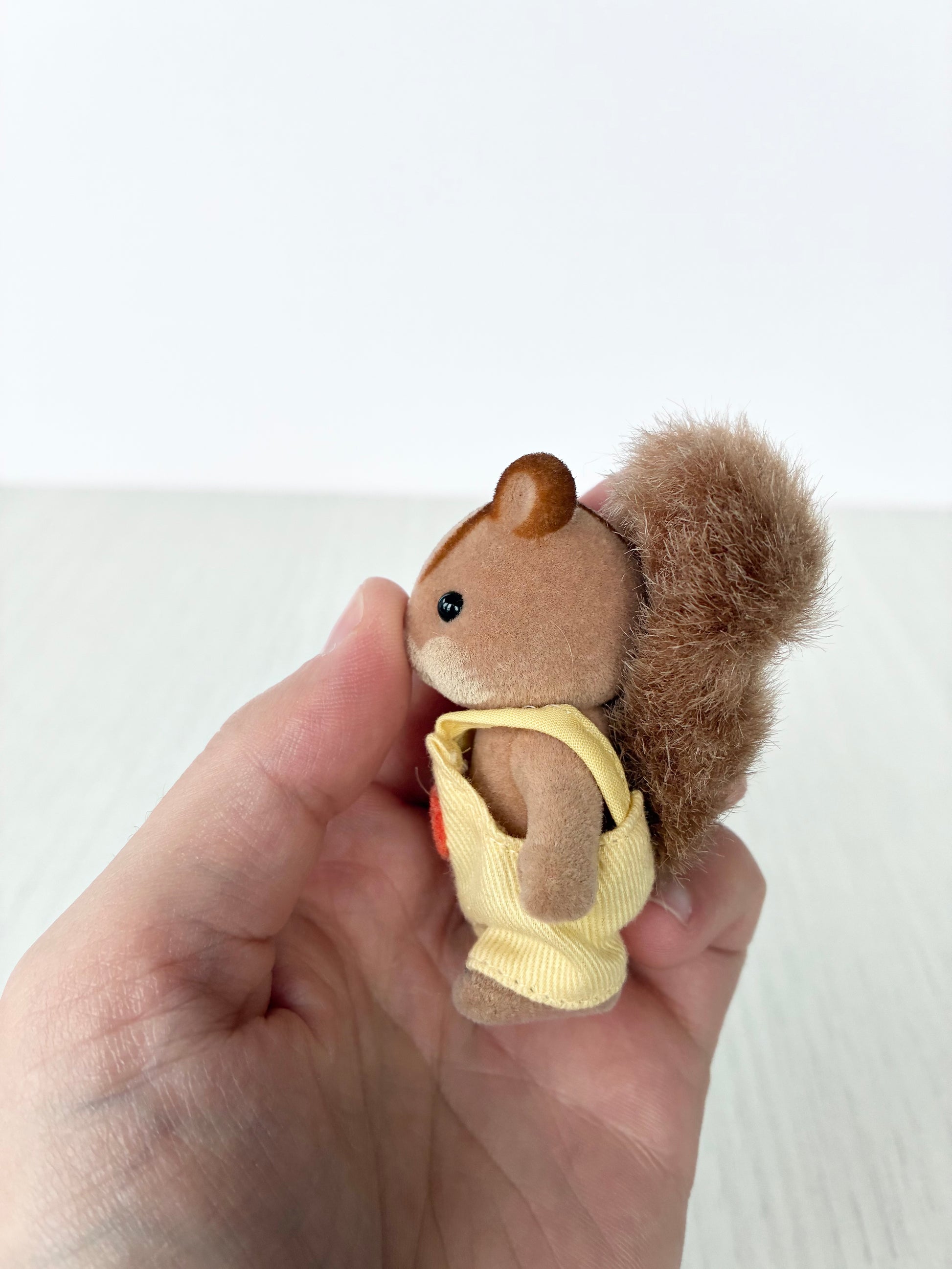 Calico Critters Sylvanian Families squirrel baby with bushy tail, side view