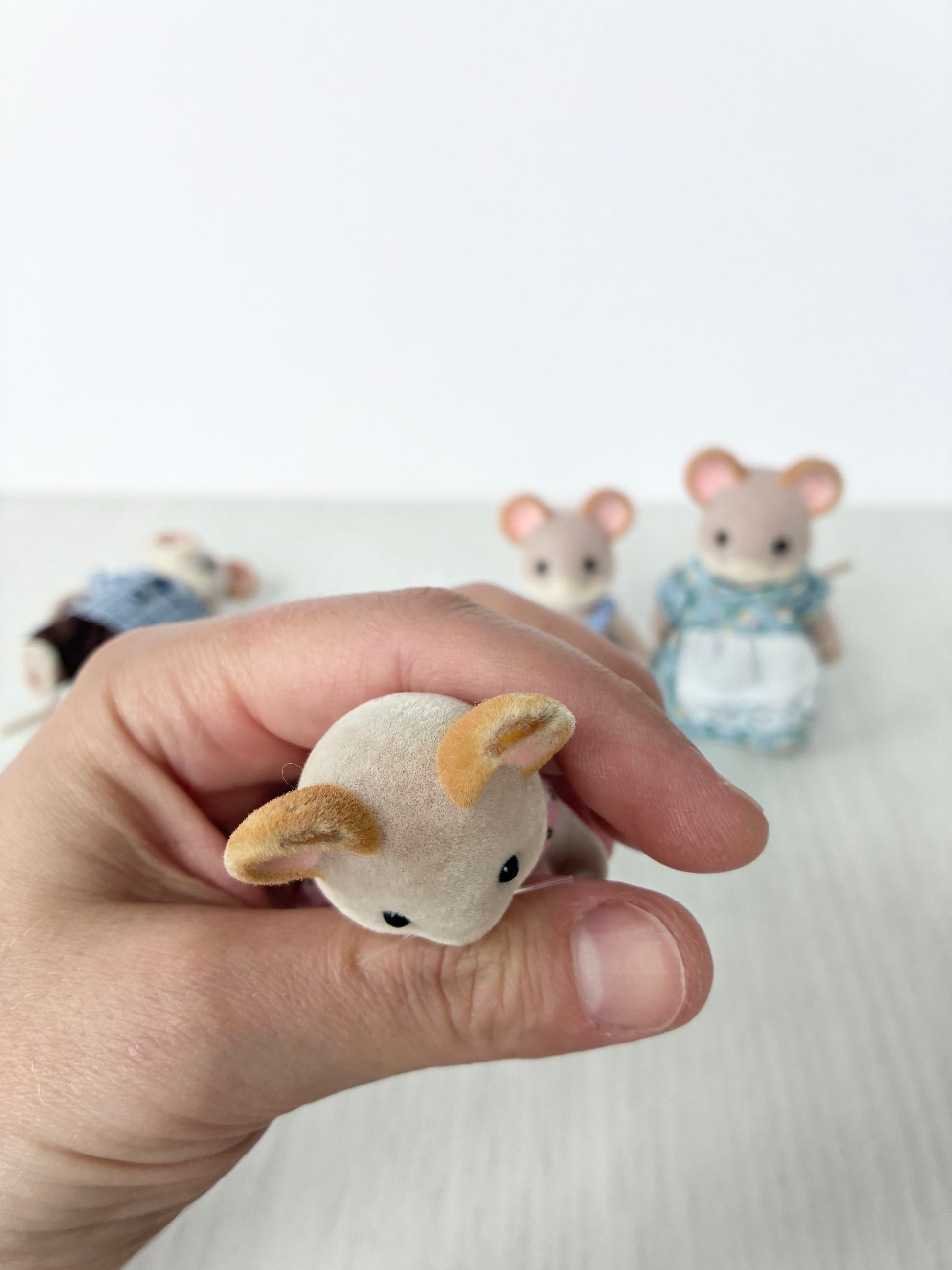 Calico Critters Sylvanian Families mouse figure held in hand