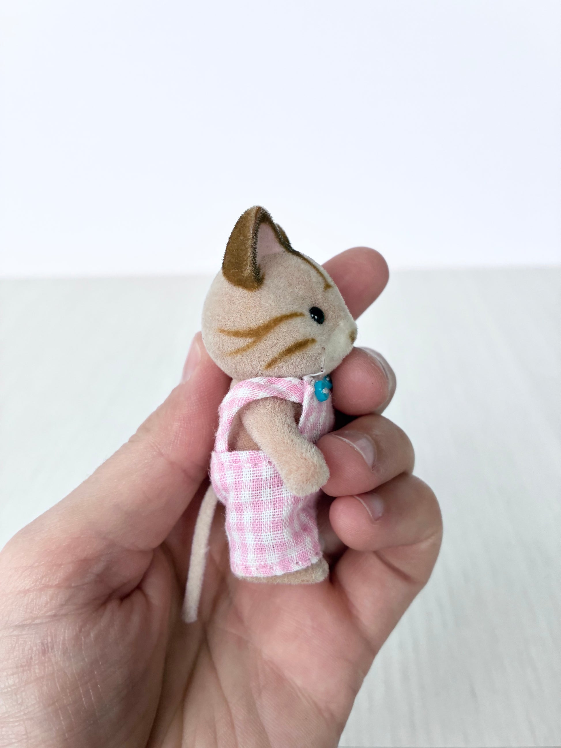 Calico Critters Sylvanian Families tabby cat boy figure held in hand