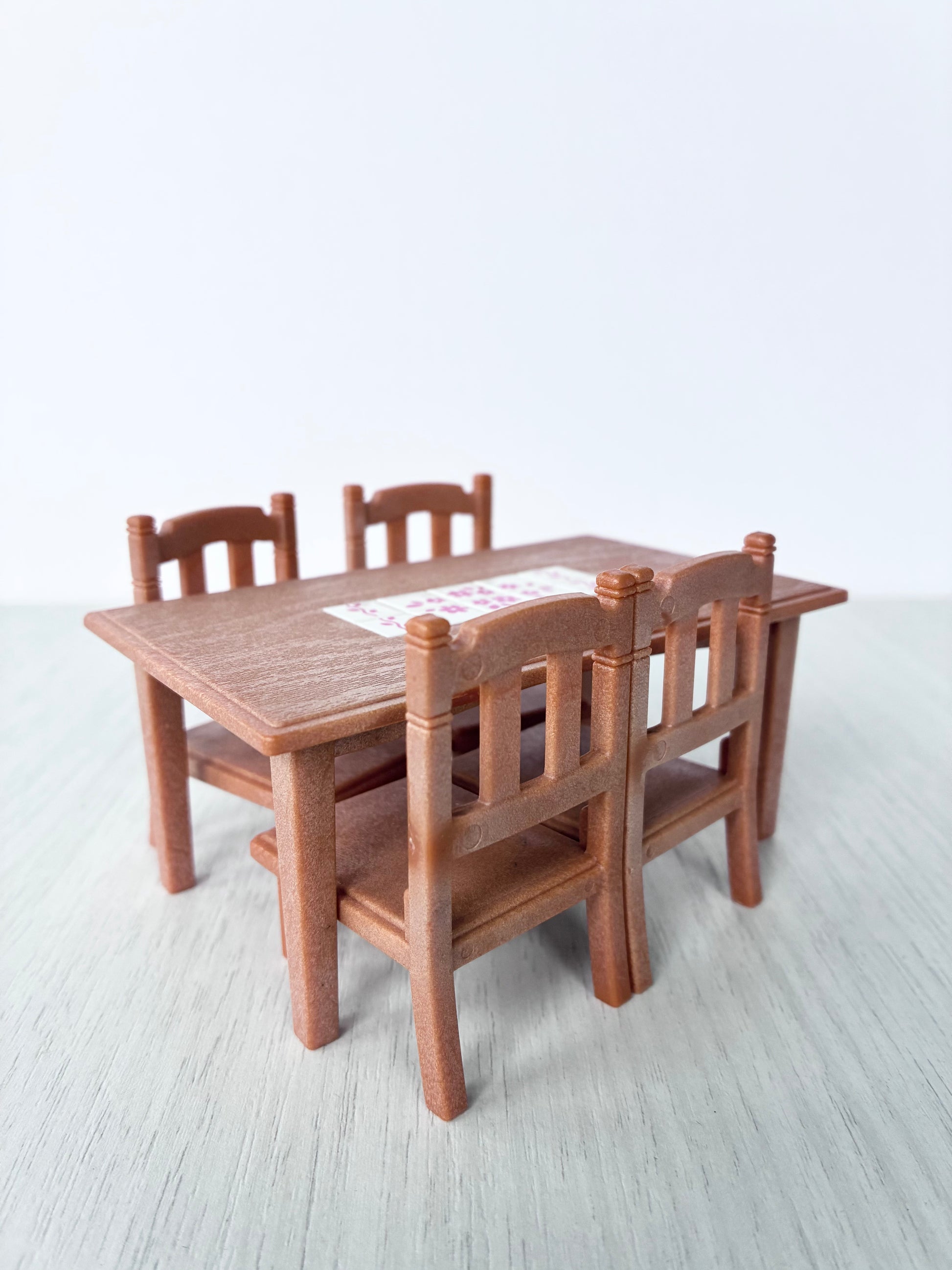 Calico Critters Sylvanian Families dining table and four chairs, angled view