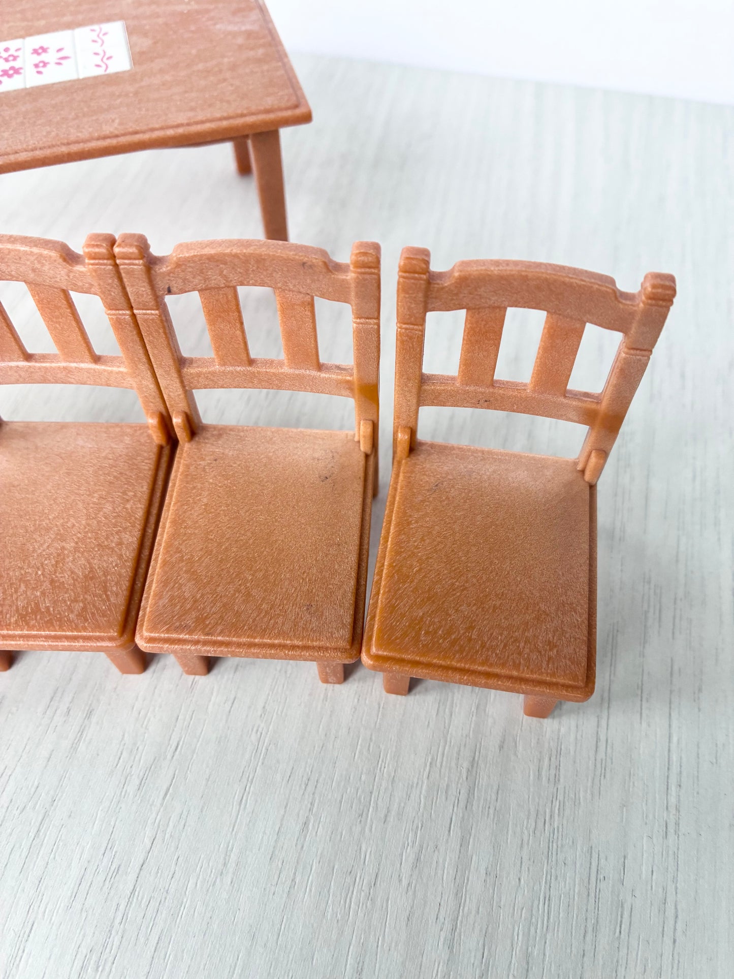 Detail of Calico Critters Sylvanian Families dining chairs showing sturdy wooden backs