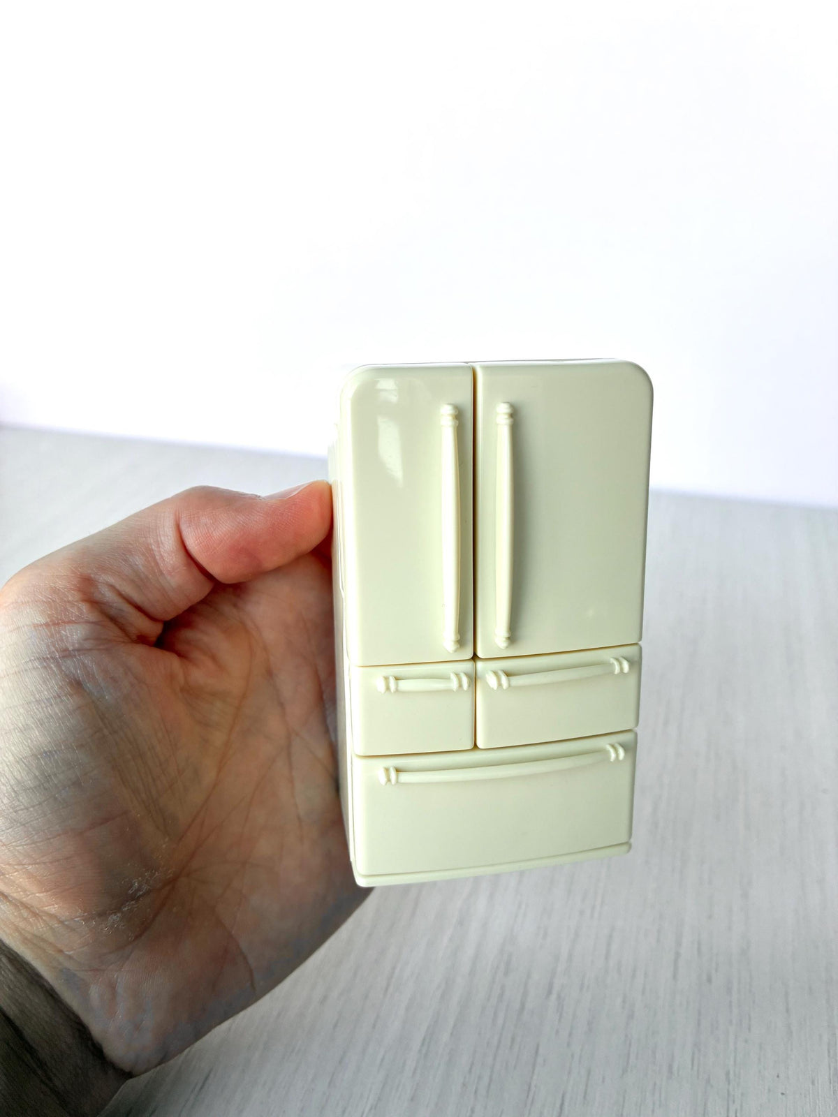 Miniature dollhouse fridge freezer, Calico Critters Kitchen Play Set, Sylvanian Families - closed front view held in hand