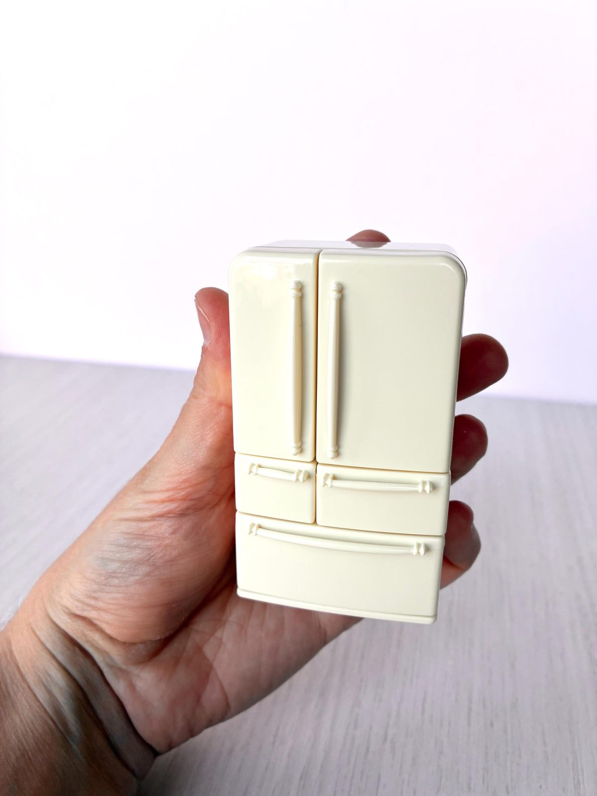 Miniature dollhouse fridge freezer, Calico Critters Kitchen Play Set, Sylvanian Families - closed front view held in hand