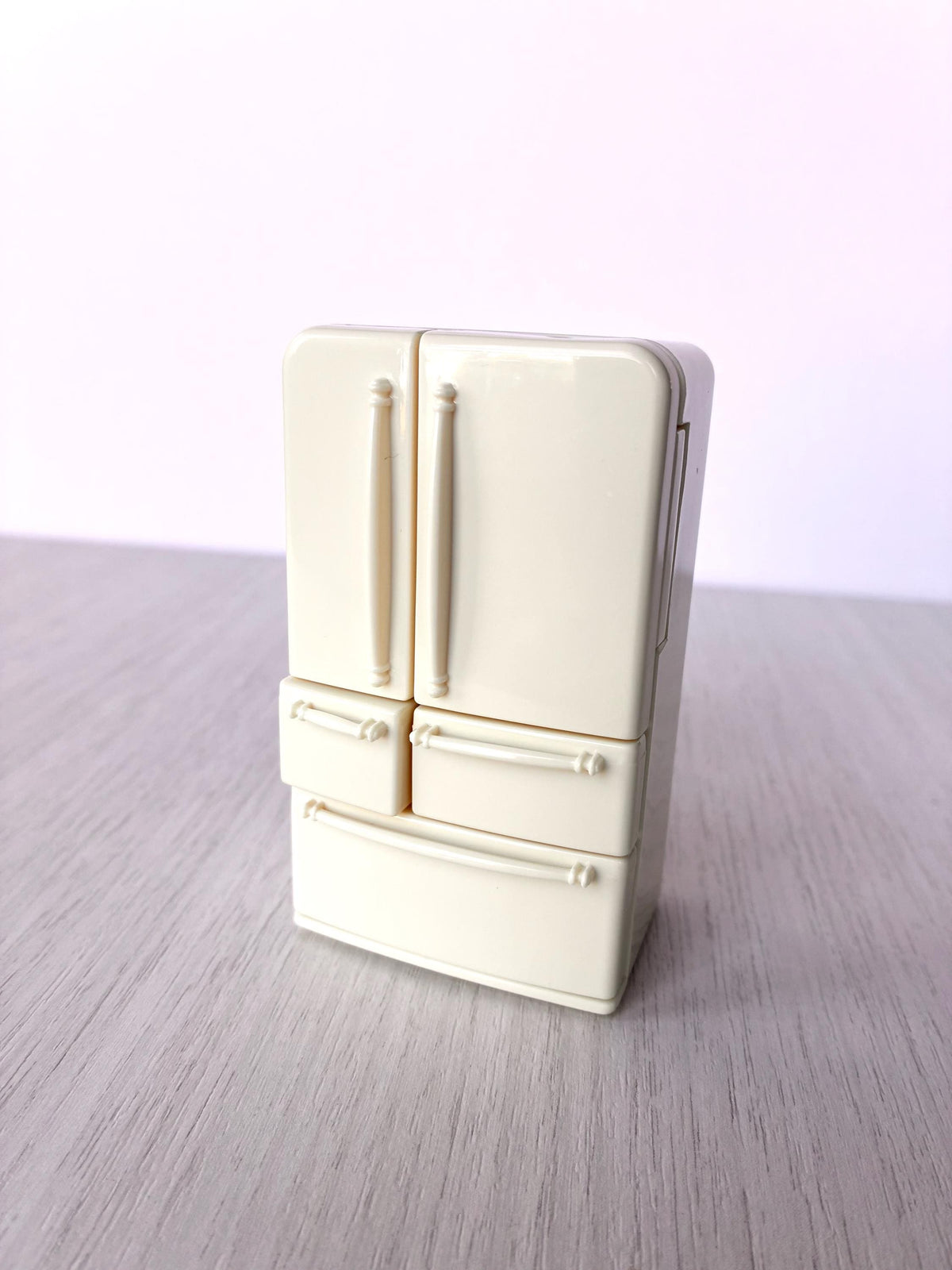 Miniature dollhouse fridge freezer, Calico Critters Kitchen Play Set, Sylvanian Families - closed fridge standing on the table