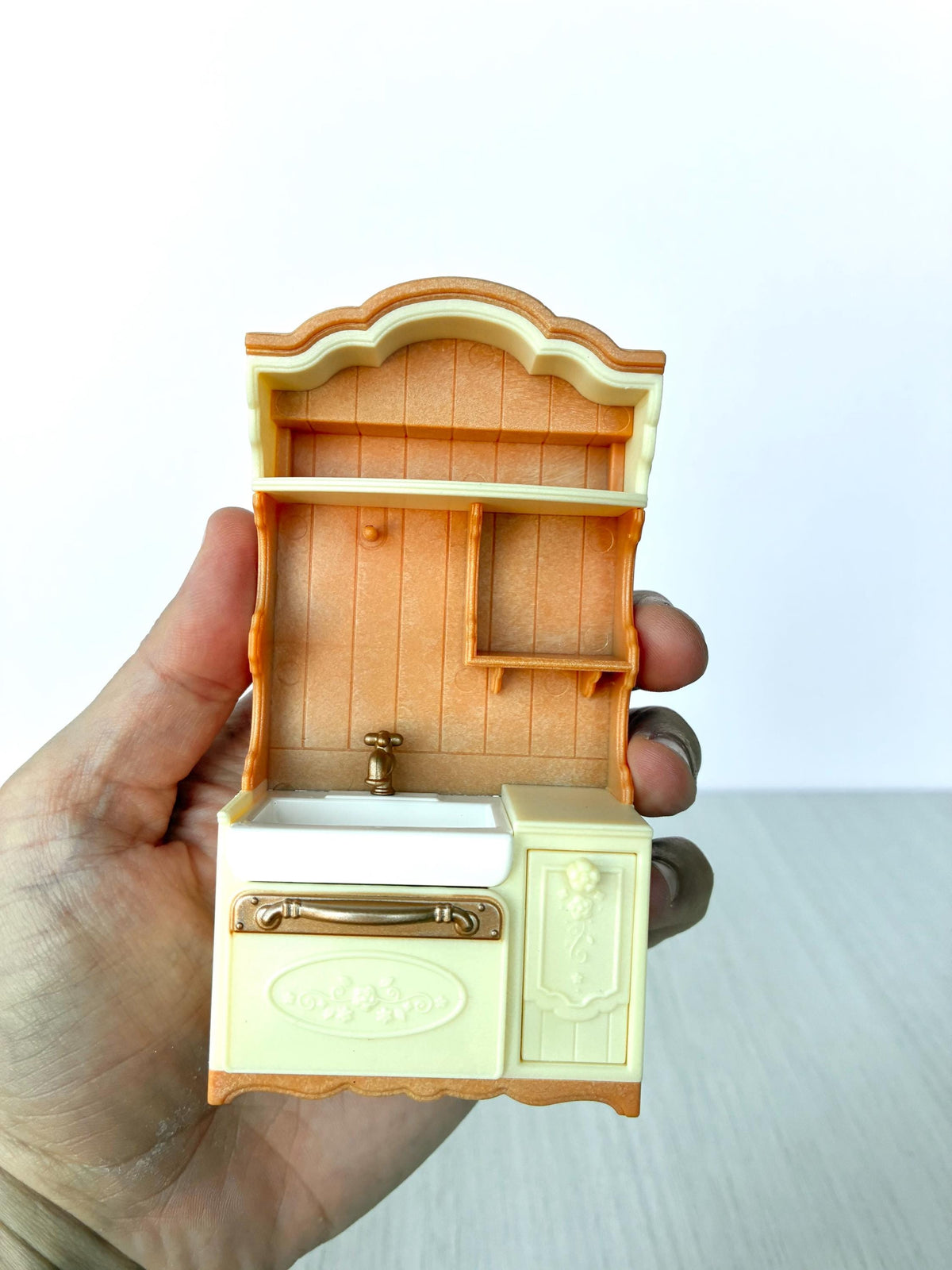 Miniature dollhouse kitchen sink unit, Calico Critters Kitchen Play Set, Sylvanian Families - front view held in hand