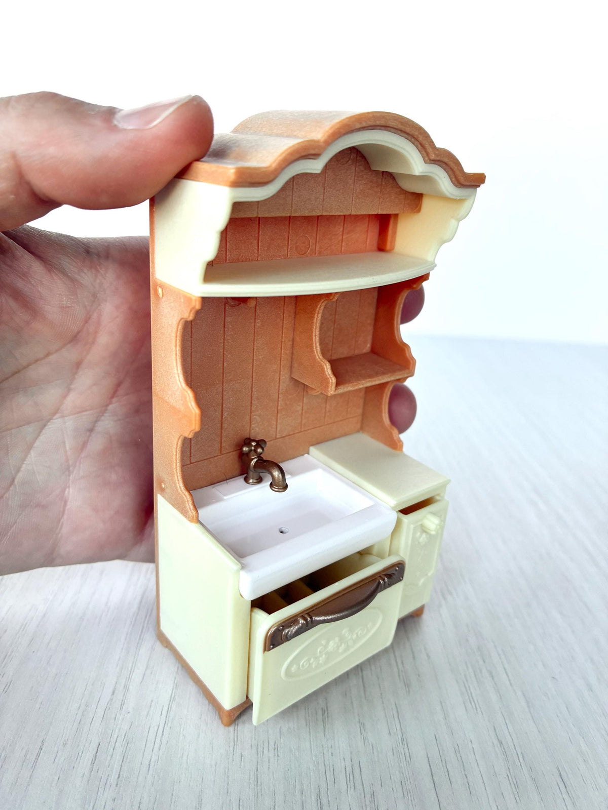 Miniature dollhouse kitchen sink unit, Calico Critters Kitchen Play Set, Sylvanian Families - held in hand with the drawer pulled open