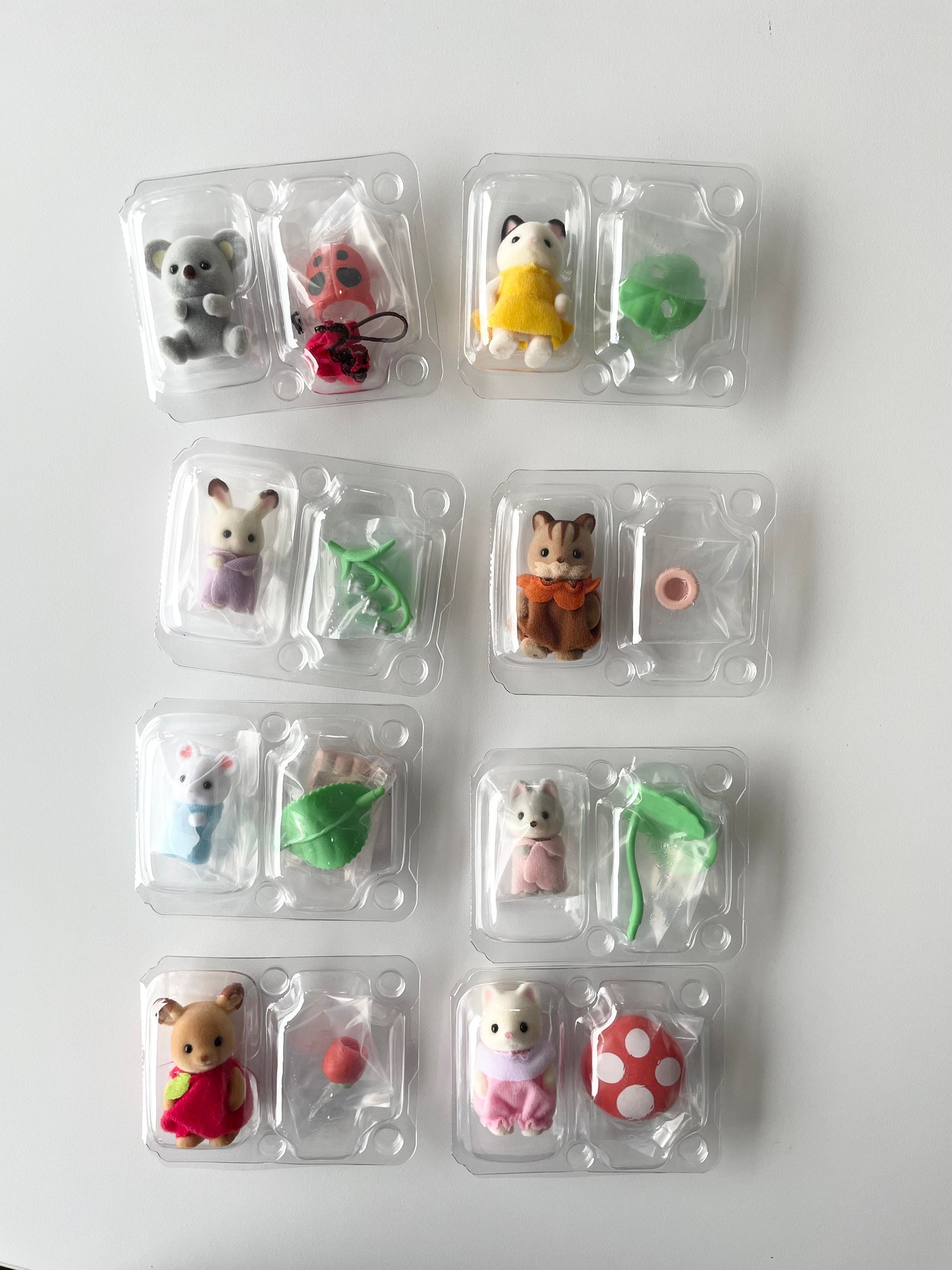 You pick Calico Critters baby forest costume series blind bag figures. Sylvanian Families collectible baby critters in fairytale outfits like mushroom, ladybug, a leaf boat, and apple. Comes brand new out of box, no guess work!