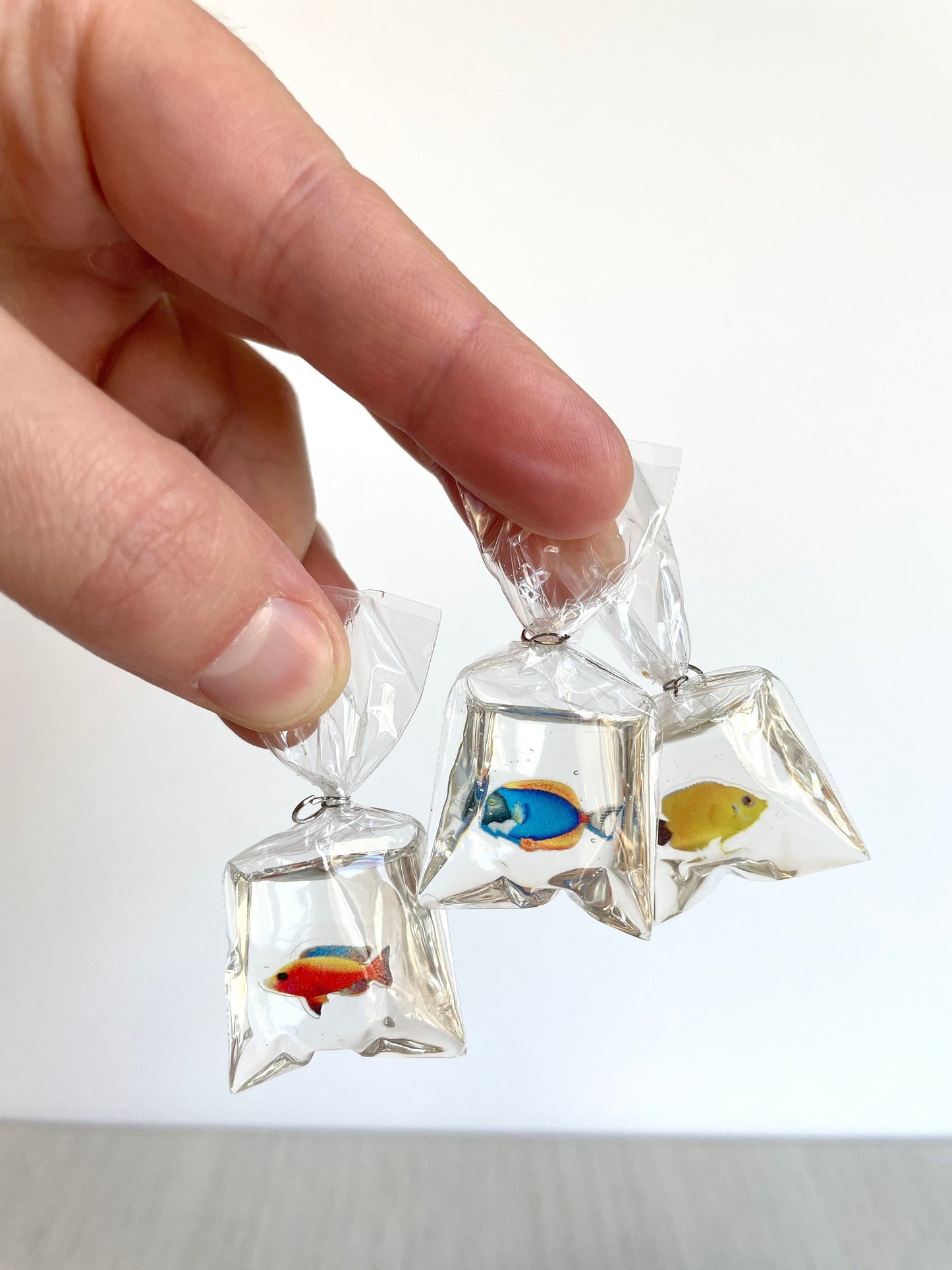 Miniature pet fish in a clear plastic bag with resin that looks like water. 1:12 scale dollhouse figurine tiny animal. Miniature fish in a clear plastic bag, perfect for dollhouse decor, DIY crafting, and Sylvanian Families scenes
