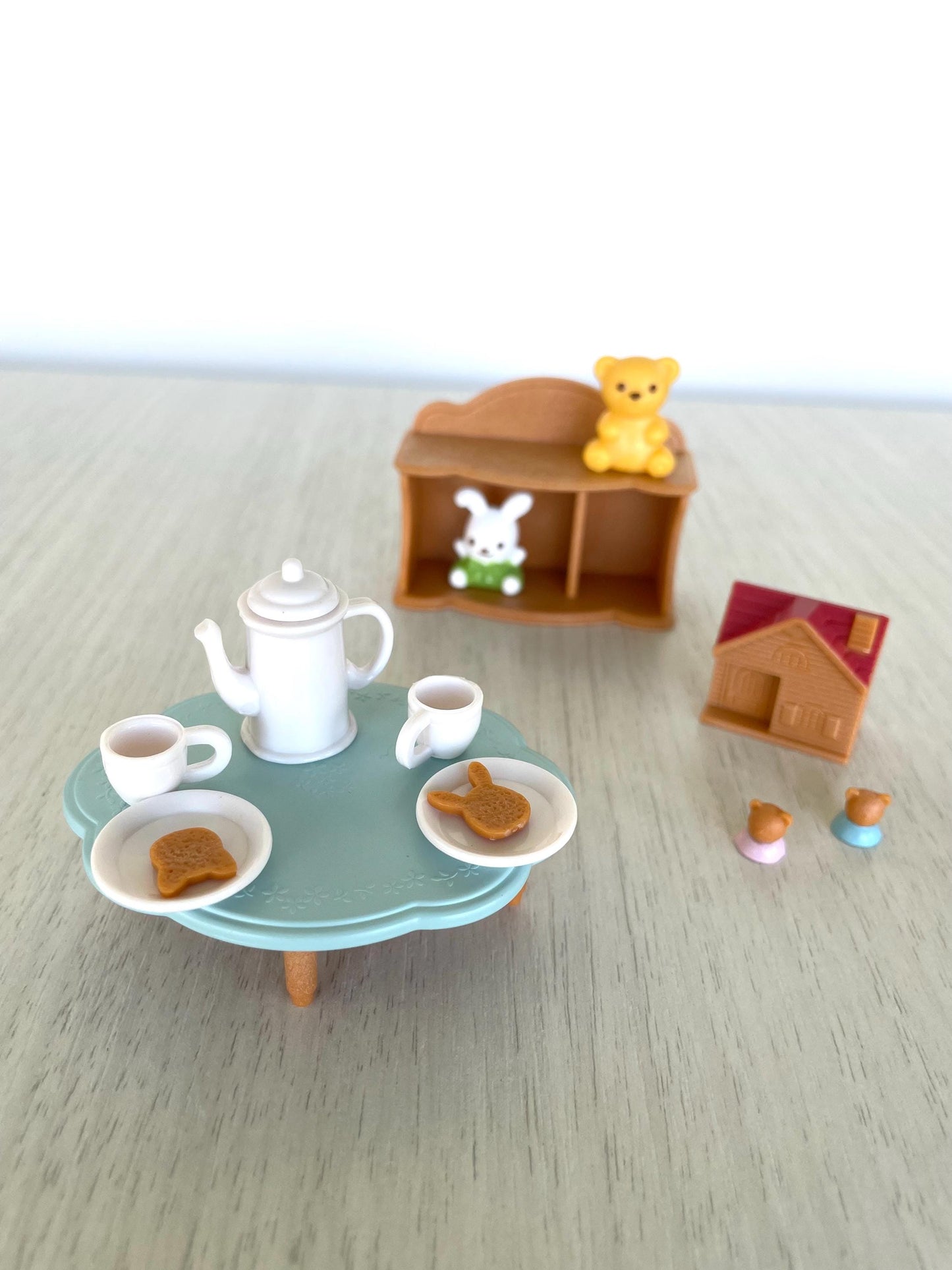 Calico Critters baby toys and tea party set with mini toy house, tea cups and kettle, cookies, little blue table, bookshelf, toy stuffies — Sylvanian Families