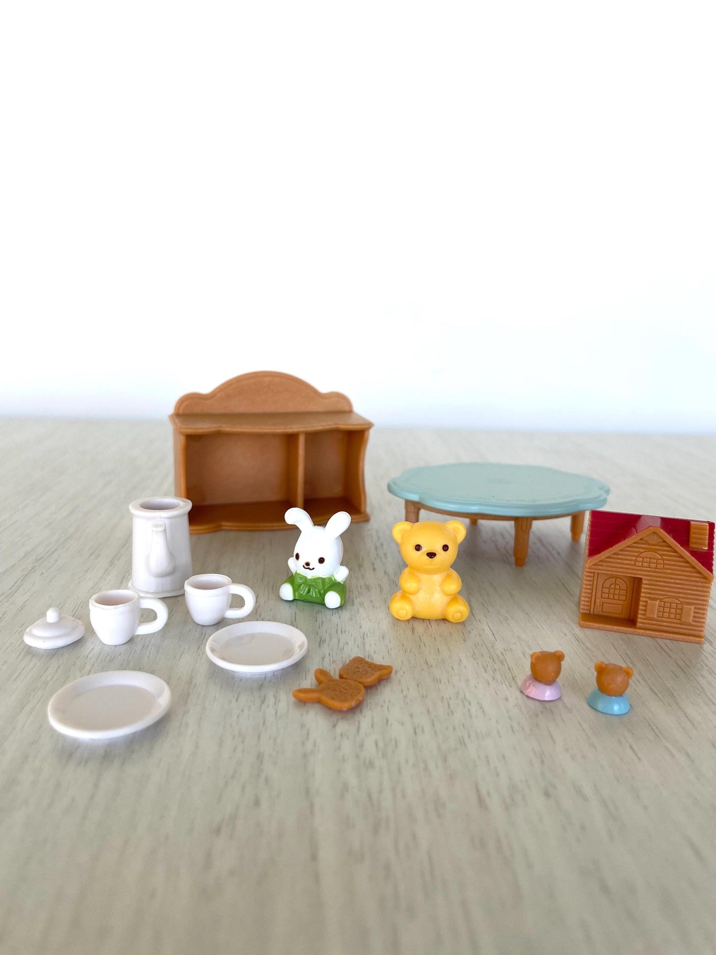 Calico Critters baby toys and tea party set with mini toy house, tea cups and kettle, cookies, little blue table, bookshelf, toy stuffies — Sylvanian Families