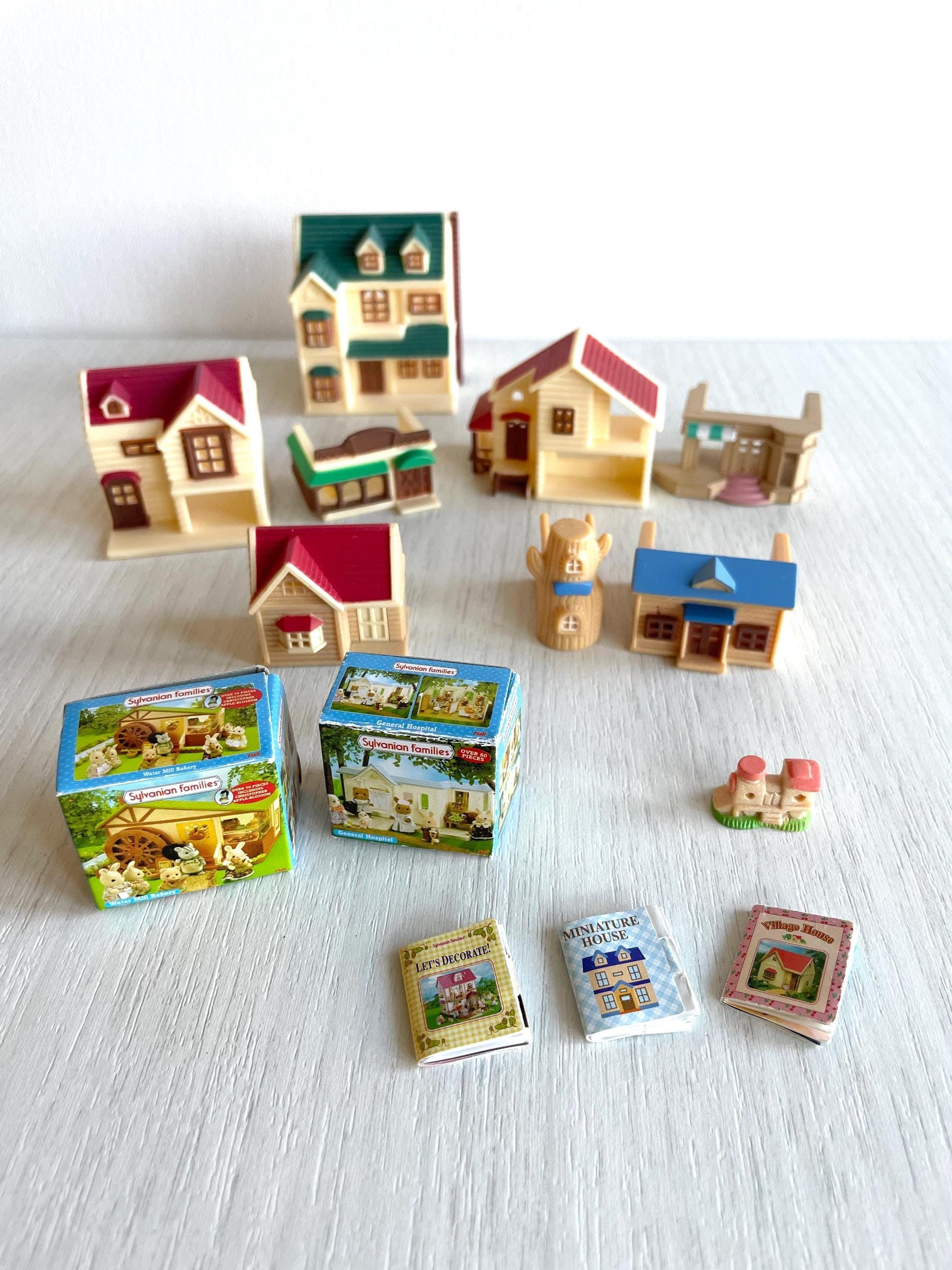 Miniature dollhouse replacement parts from vintage Sylvanian Toy Shop, Calico Critters tiny dollhouses with toy boxes and magazines. House on the hill, grape forest house, kitchen restaurant, woodland lodge, applewood department, rose cottage