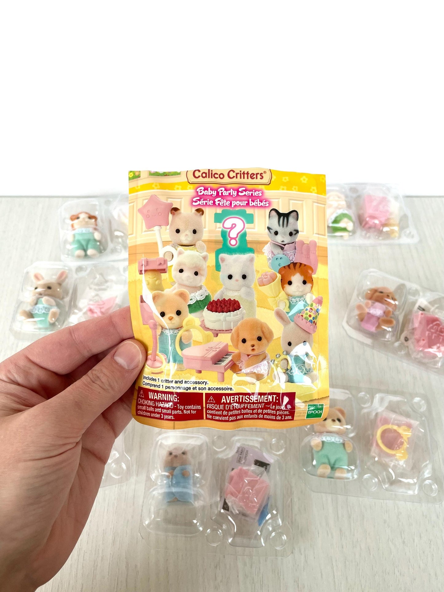 Calico Critters Baby Party Series Blind Bag - Surprise collectible baby critters including bunnies, kittens, puppies, and more. Ideal for collectors and kids, these blind bags feature adorable party-themed figures