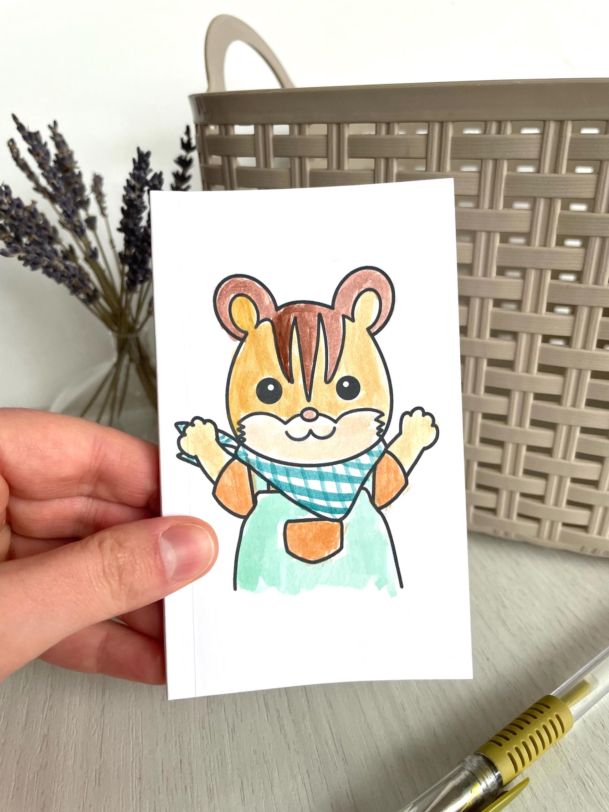 Handmade Sylvanian Families notebook featuring a custom watercolor design, perfect for fans and collectors of Calico Critters. This 3x5-inch journal includes 25 thick blank pages, ideal for journaling, sketching, or note-taking. The notebook is hand-bound with love, ensuring each piece is unique. A great personalized gift for kids or Sylvanian Families enthusiasts. Crafted with care, it’s the perfect addition to any collection or as a cute, functional stationery piece.