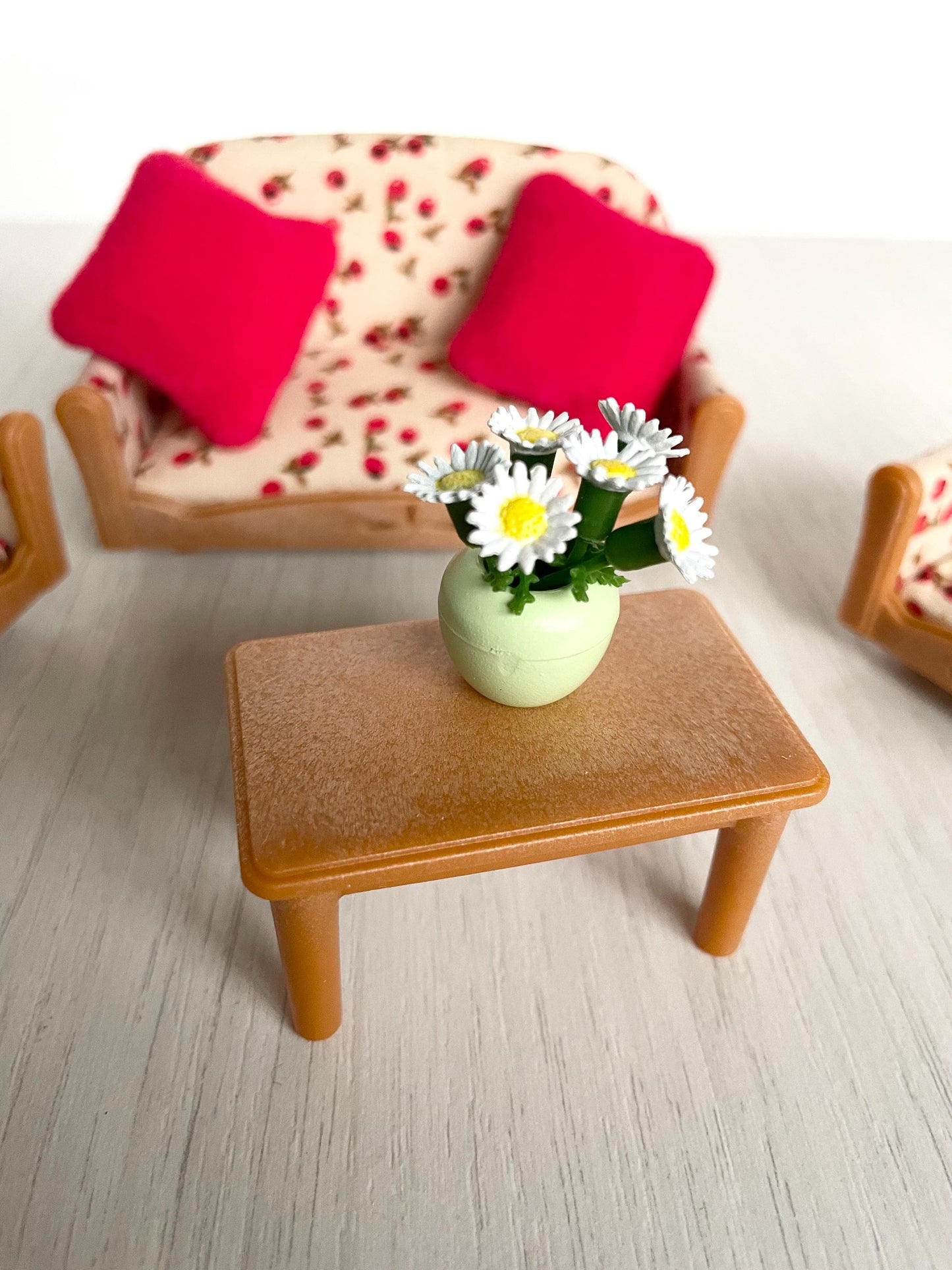 Calico Critters floral couch living room set with white flowers in vase and red pillows, Sylvanian Families couch and armchair set