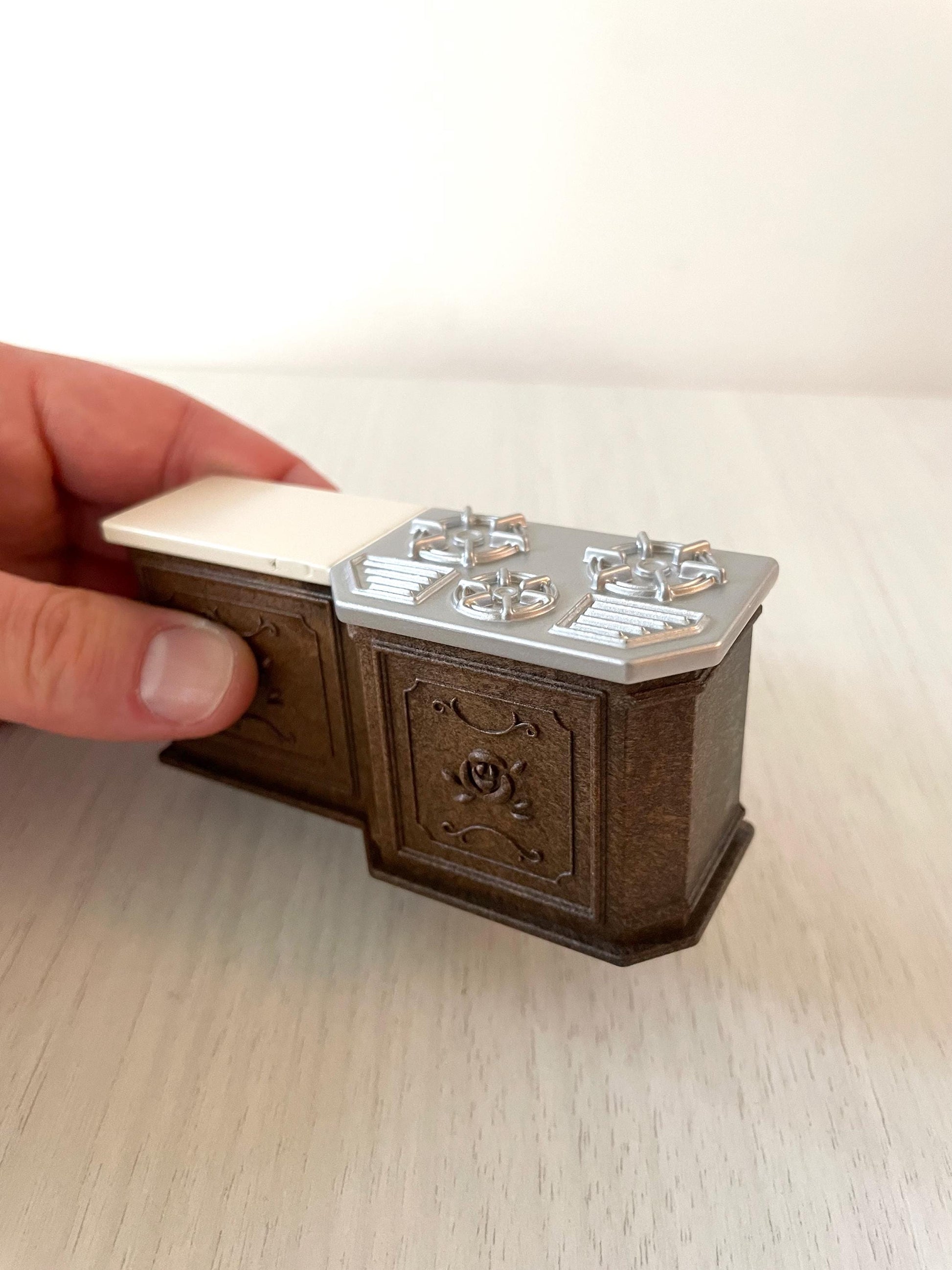 Dark brown ornate Calico Critters kitchen cabinet with chrome cooktop stove, oven replacement miniatures furniture for dollhouse. Replacement part for the Delicious Restaurant.
