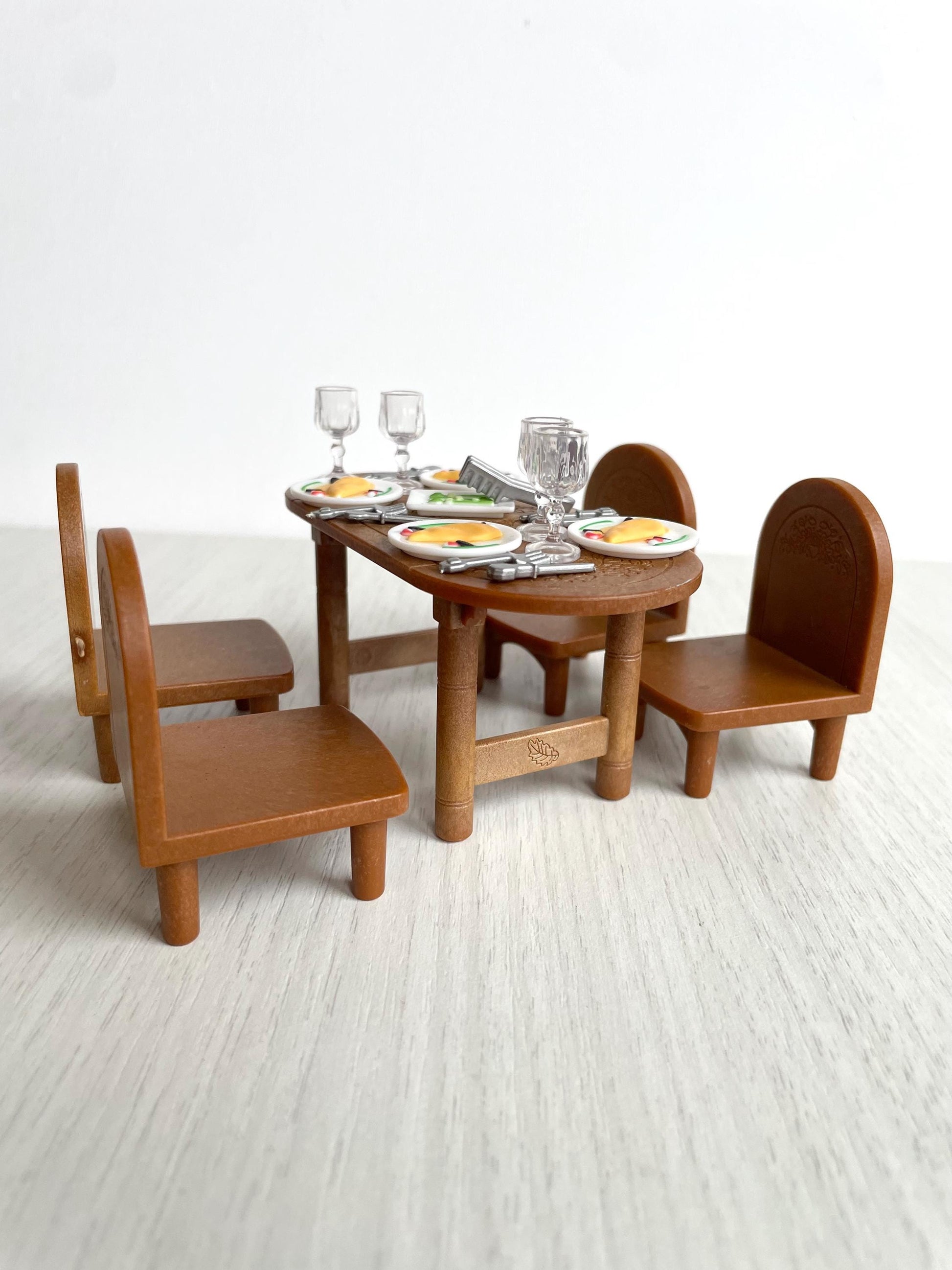 Vintage Sylvanian Families dining room table set with four chairs and dishes — Calico Critters