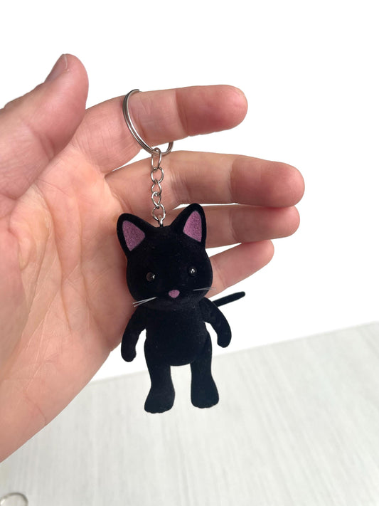 Black cat keychain featuring a cute midnight cat Calico Critter, perfect for cat lovers, Halloween gifts, gothic accessories, or witchy bag charms. This kawaii black cat charm is lightweight, durable, and ideal as a pet memorial keepsake or zipper pull. Great for backpacks, keys, or gifting to cat moms and spooky season fans.