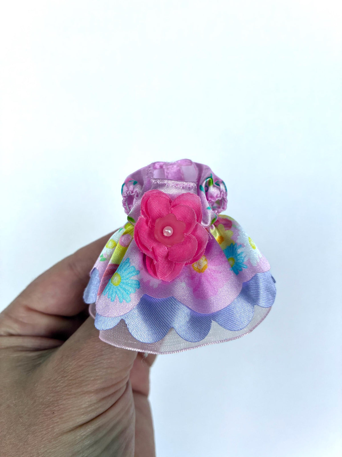 Calico Critters Flowering Princess dress in lilac and purple floral fabric with a pink flower and tiered ruffles, a child-size Sylvanian Families outfit.