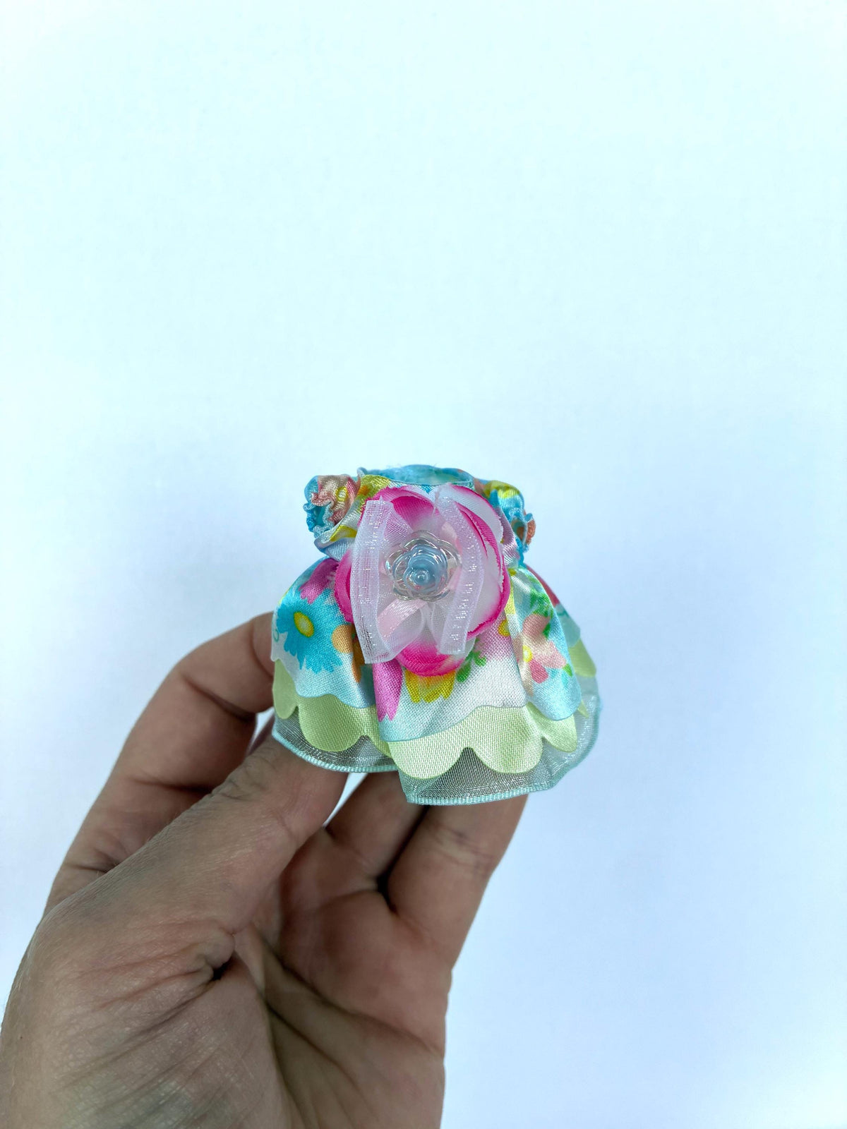 Calico Critters Flowering Princess dress in pastel floral fabric with a flower and scalloped ruffle hem, a child-size Sylvanian Families outfit.