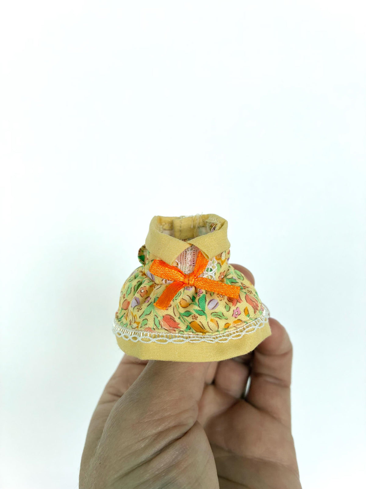 Calico Critters yellow floral dress with an orange bow and lace trim, a child-size Sylvanian Families outfit.