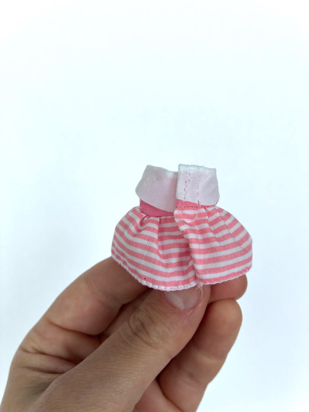 Back view of the pink and white striped child-size dress for Sylvanian Families and Calico Critters figures.