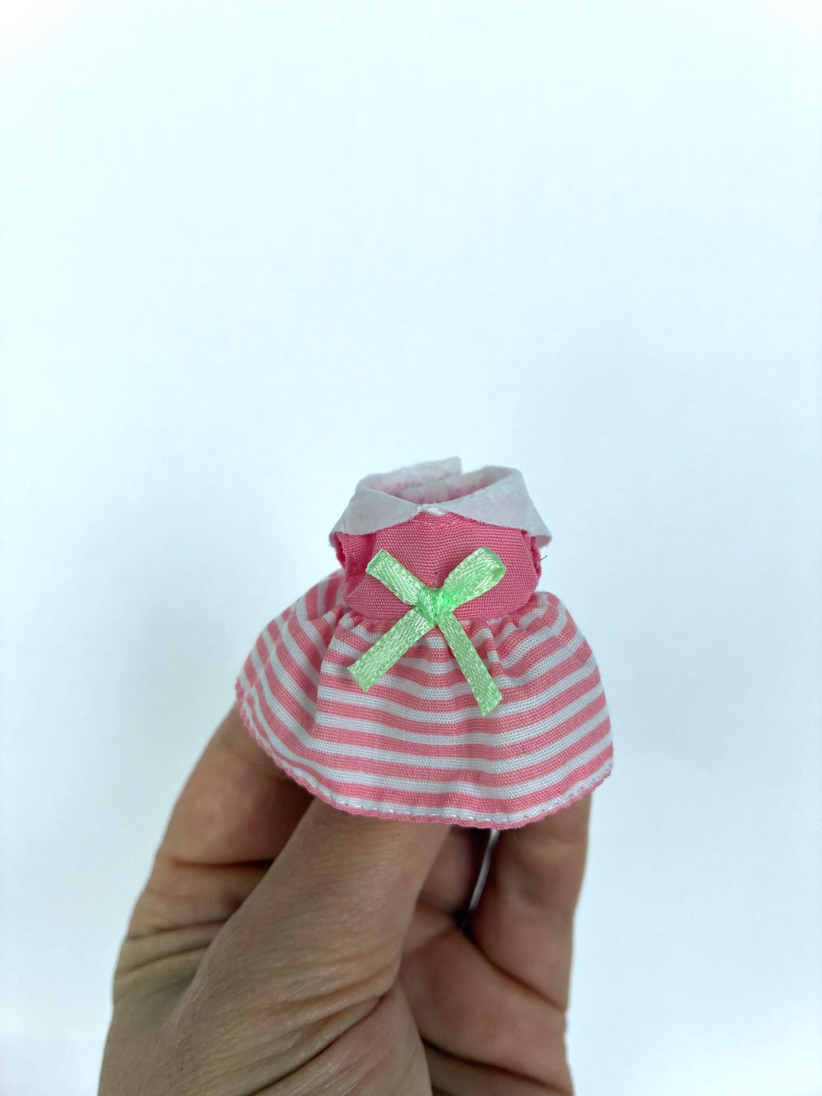 Calico Critters pink and white striped dress with a green bow, a child-size Sylvanian Families outfit.