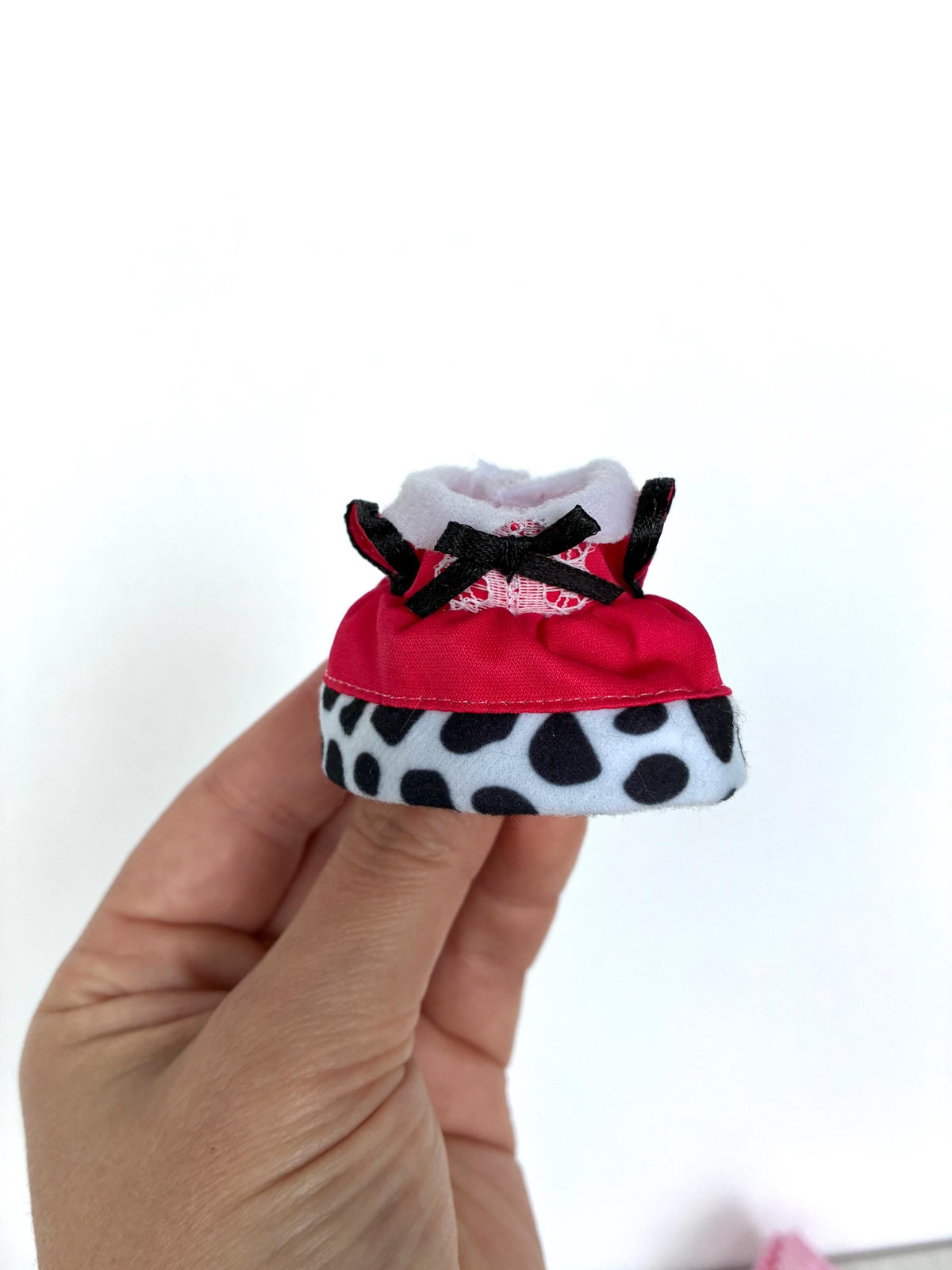 Calico Critters Dalmatian dress with a hot pink top, black bow, and black-and-white polka dot skirt, a child-size Sylvanian Families outfit from the new Dalmatians release.