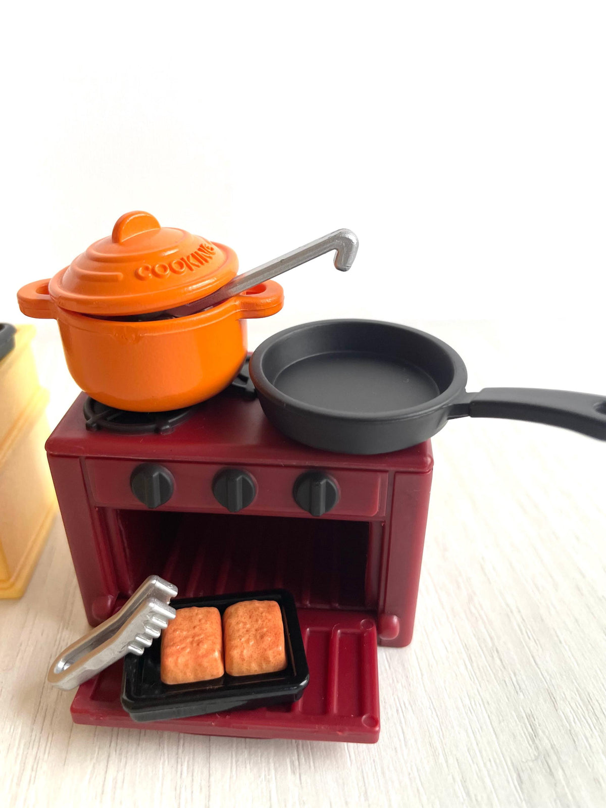 Burgundy cooker with open oven door, casserole pot and frying pan, vintage Calico Critters Sylvanian Families kitchen set
