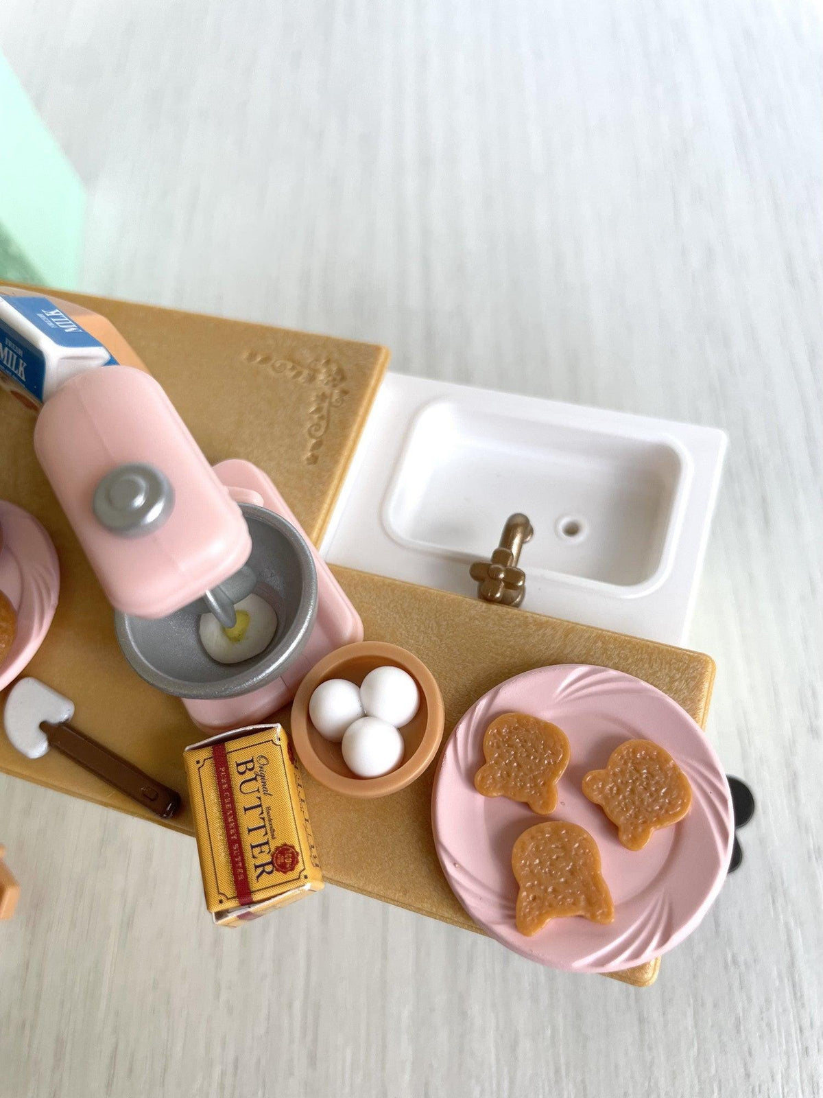 Overhead view of the baking counter with sink, butter, eggs and toast — Calico Critters and Sylvanian Families