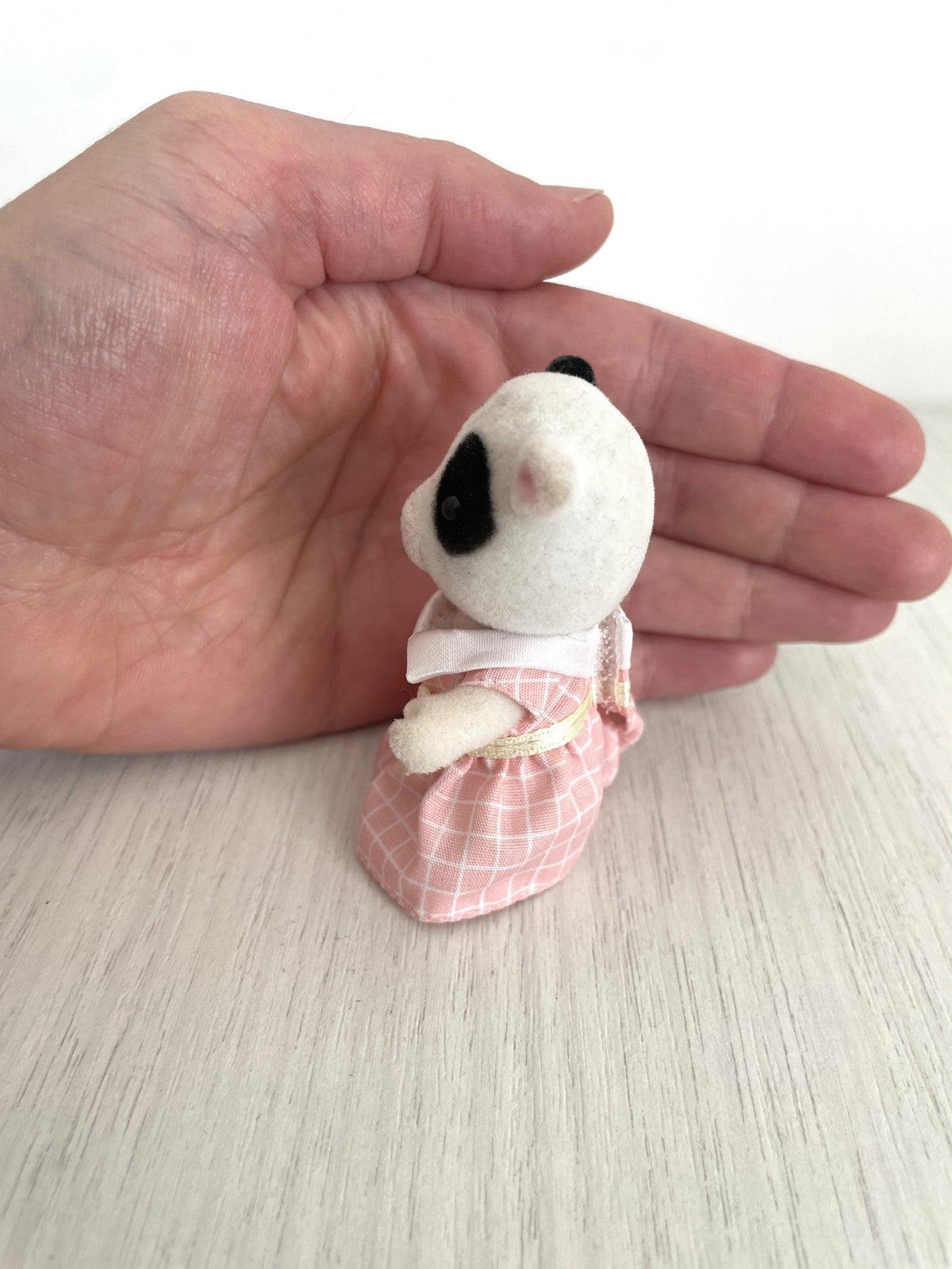 Side view of the cow girl and her pink check dress — Calico Critters and Sylvanian Families