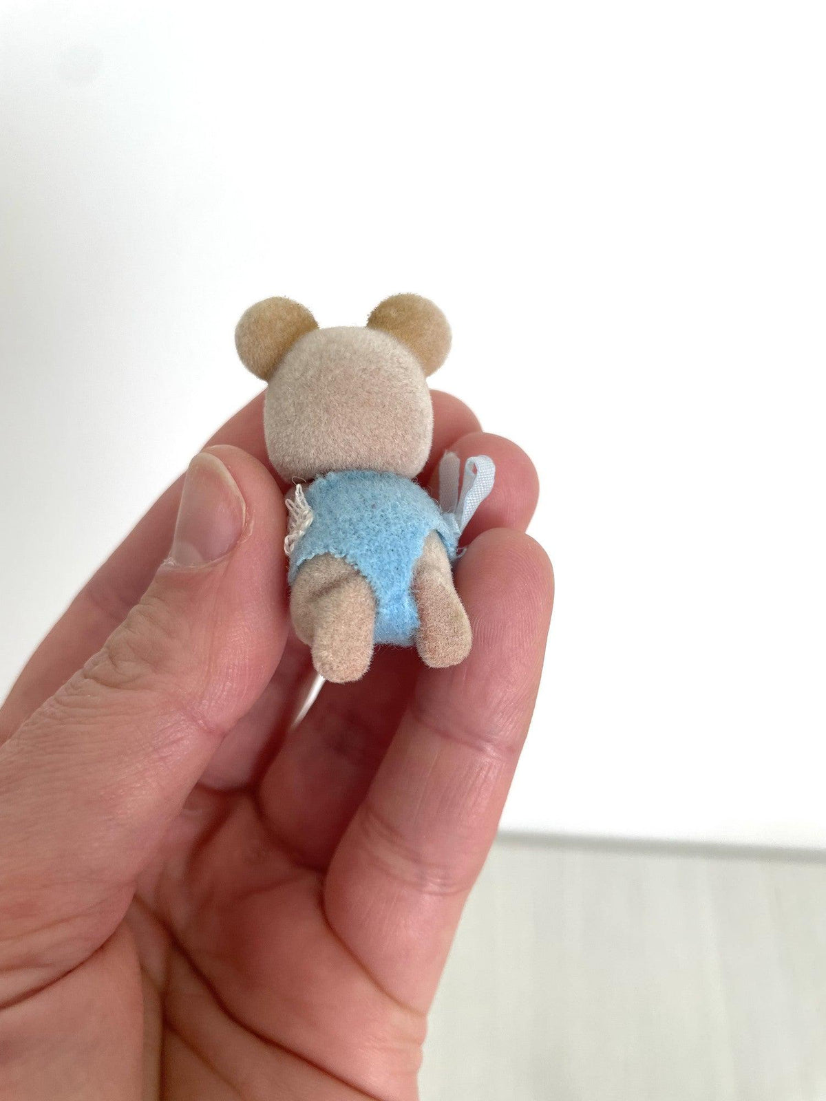 Back view of the Maces Mouse baby boy and his blue romper — Calico Critters and Sylvanian Families