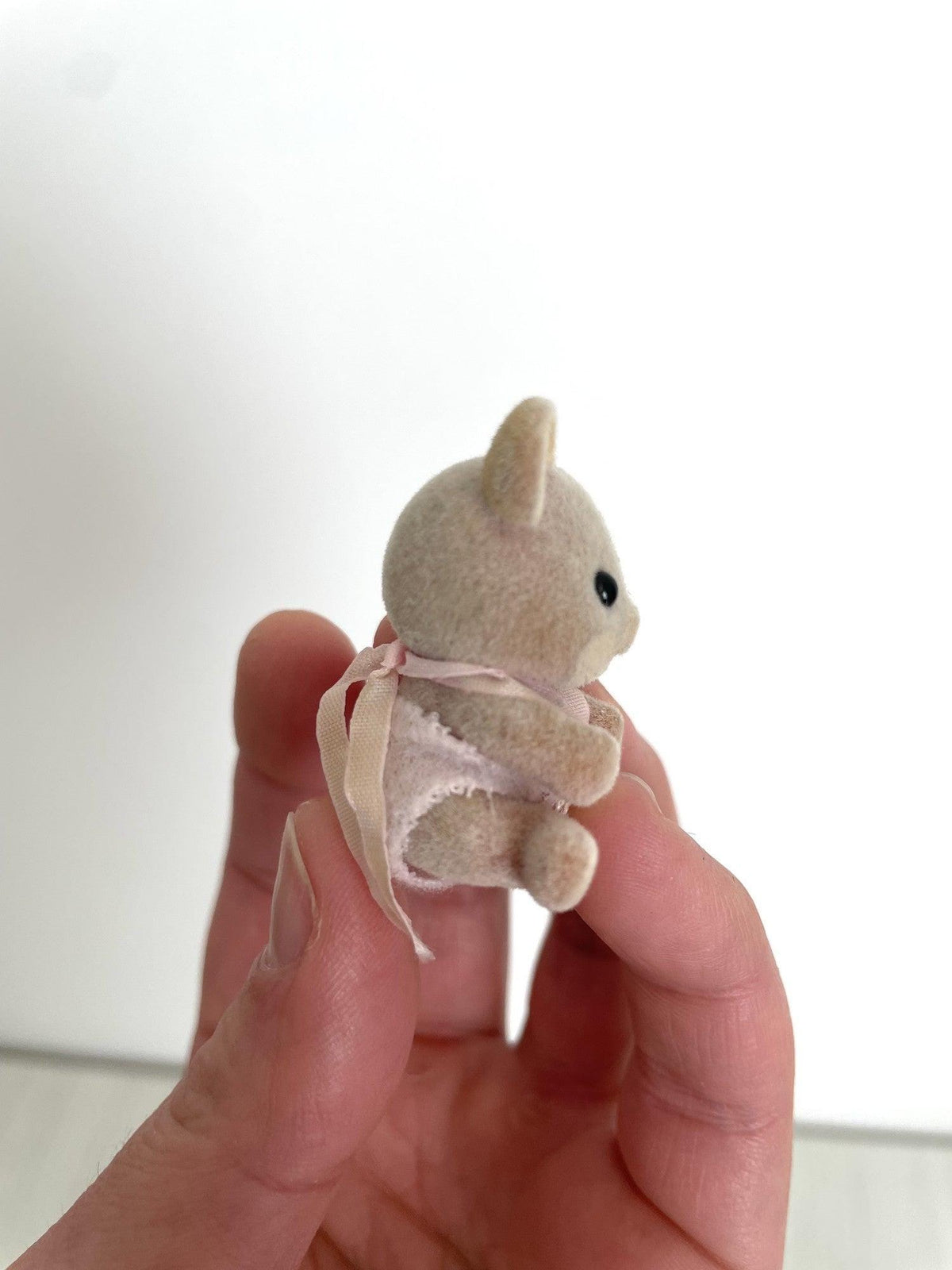 Side view of the Maces Mouse baby girl showing the pink ribbon bow — Calico Critters and Sylvanian Families