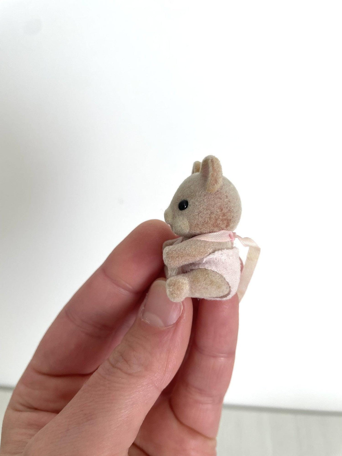 Back view of the Maces Mouse baby girl and her pink romper — Calico Critters and Sylvanian Families