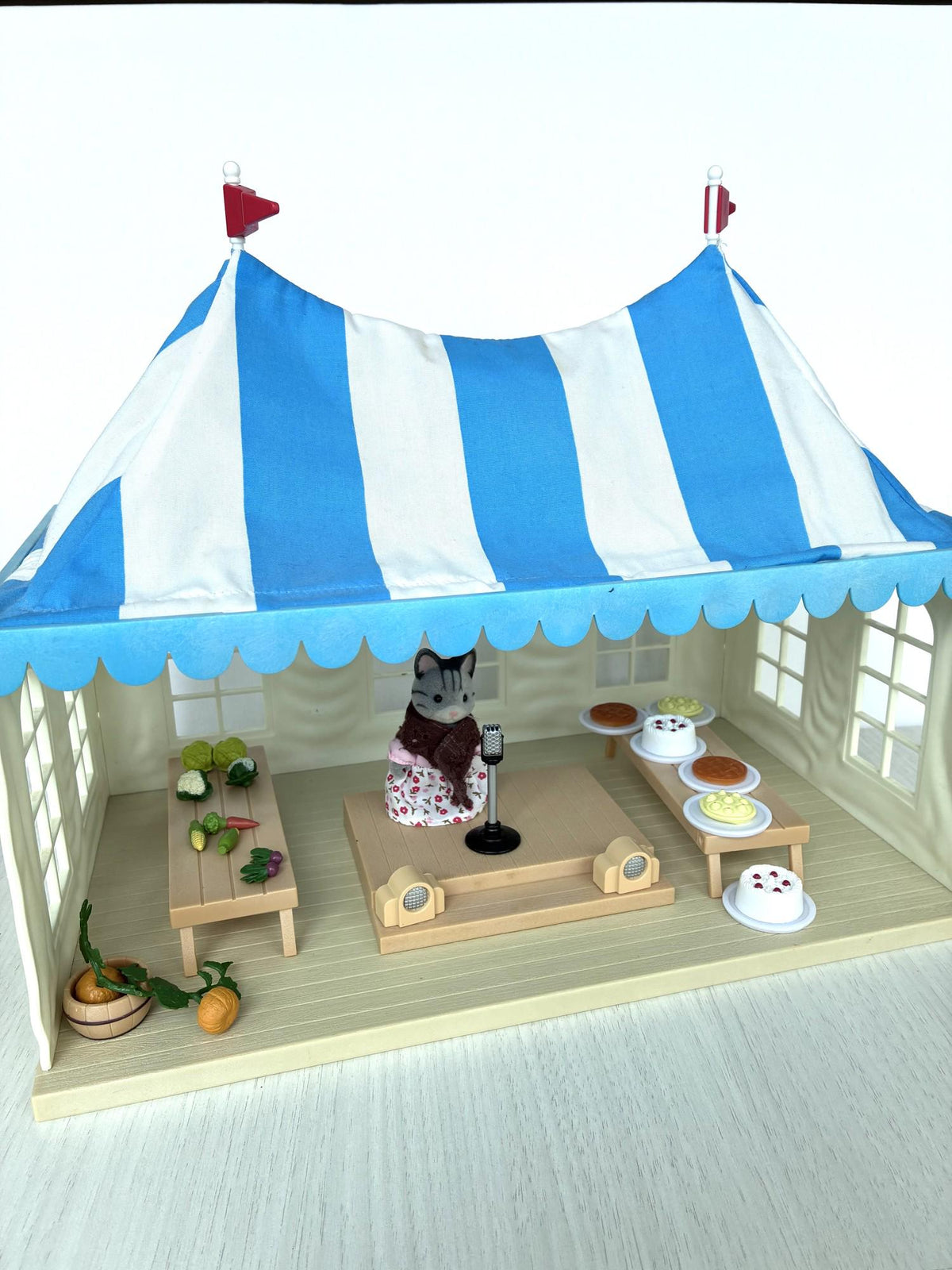 Calico Critters Sylvanian Families vintage Marquee Flair 4495, blue and white striped tent with grandmother cat figure, stage and show tables, front view