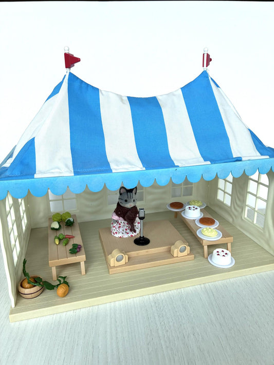 Calico Critters Sylvanian Families vintage Marquee Flair 4495, blue and white striped tent with grandmother cat figure, stage and show tables, front view