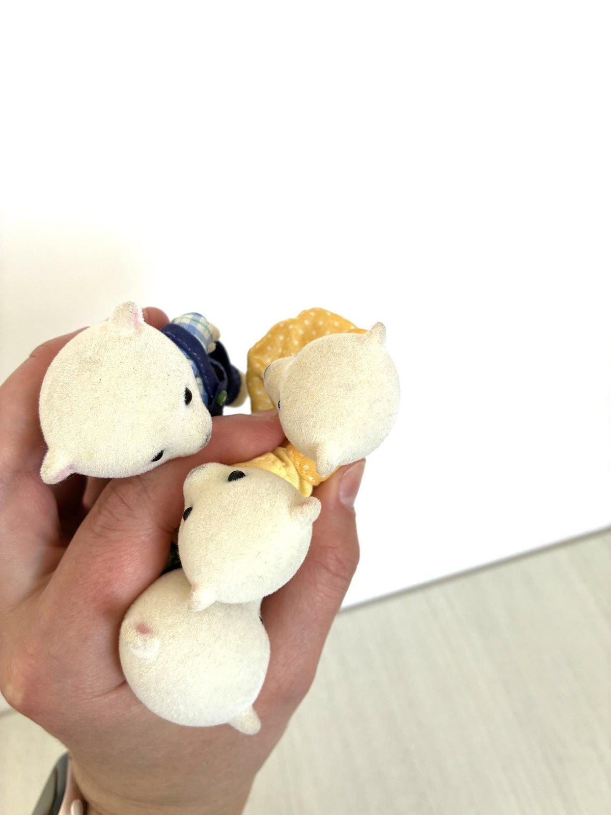 Calico Critters Sylvanian Families Beaufort Polar Bear Family figures held in hand for scale