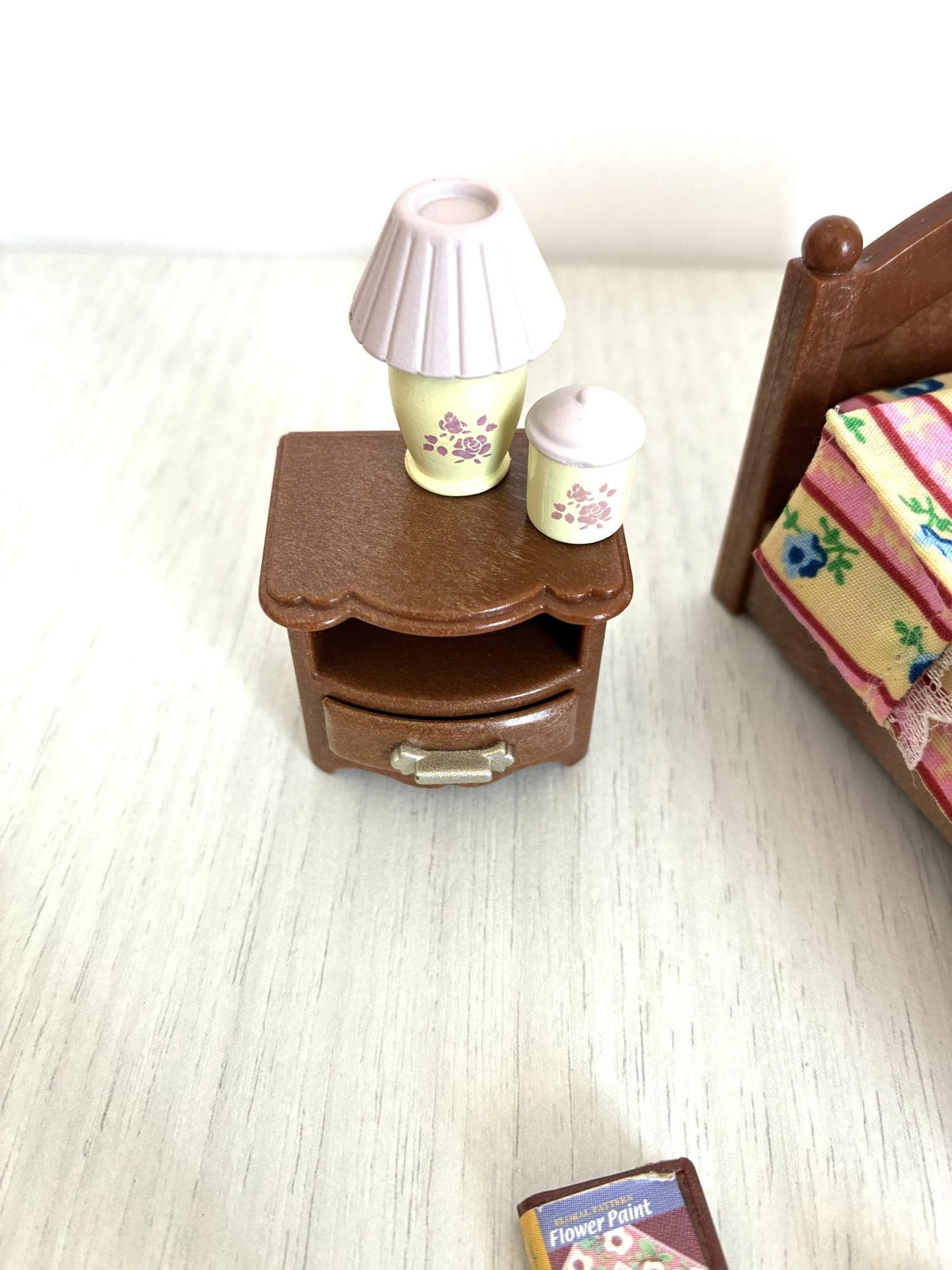 Calico Critters Sylvanian Families bedside table with drawer, pink shade lamp and cup close-up