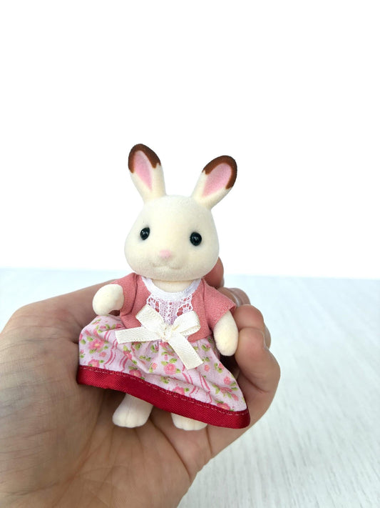 Calico Critters Sylvanian Families Hopscotch Chocolate rabbit mother in pink floral dress with bow, front view held in hand
