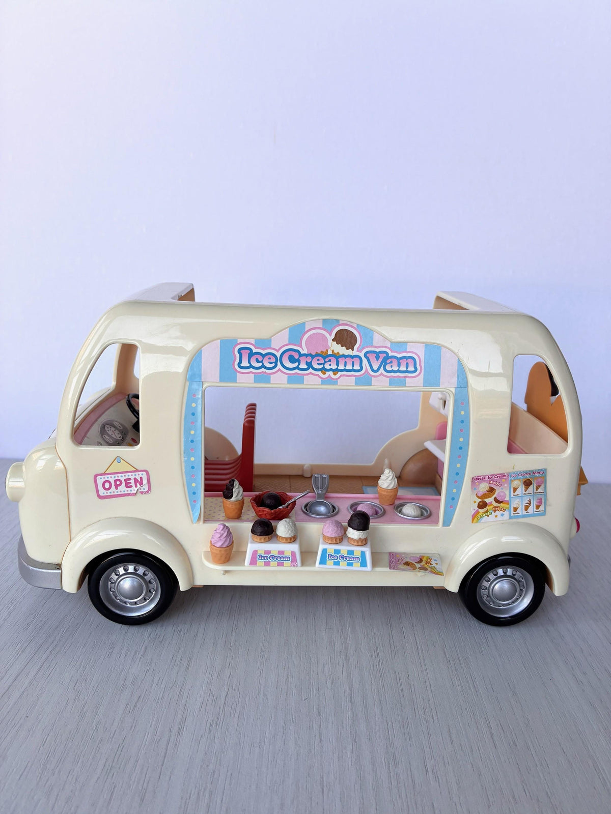 Sylvanian Families Calico Critters Ice Cream Van (Flair 4791) set up for service with ice creams on the counter and OPEN sign