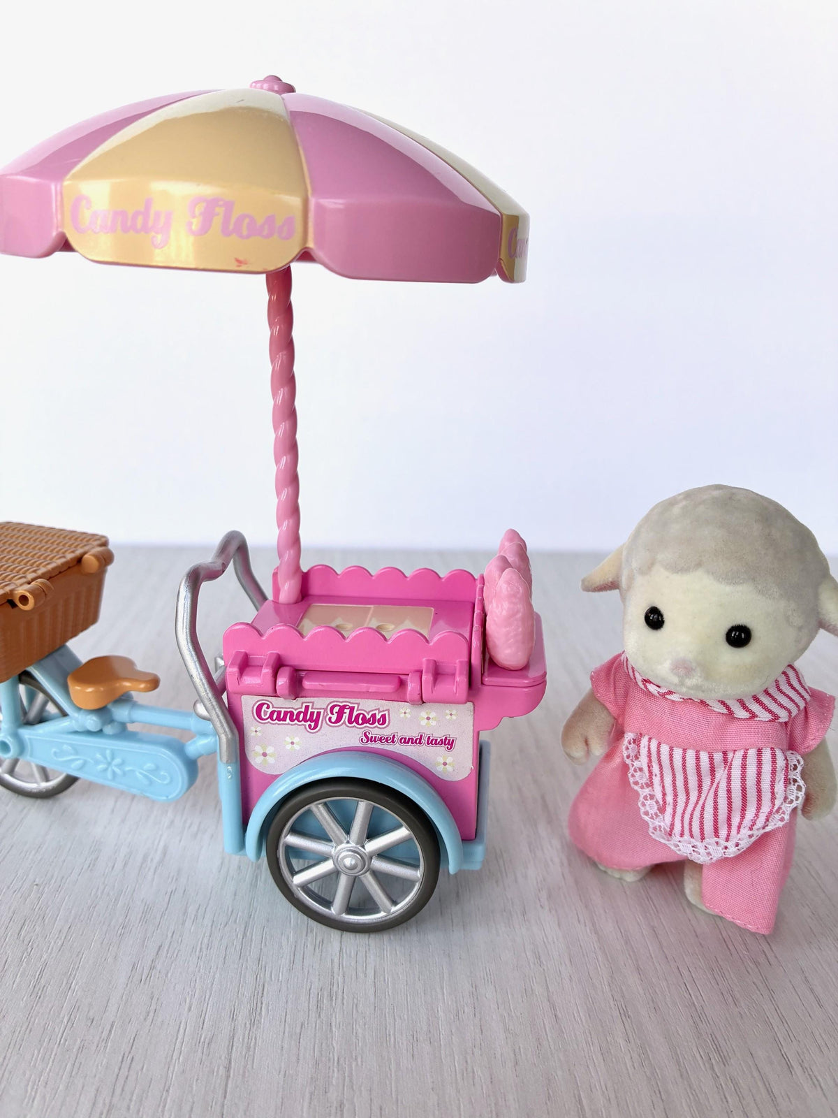 Sylvanian Families Calico Critters Dolly's Candy Floss (Flair 4678) side view of the candy floss tricycle with Dolly Dale behind the cart