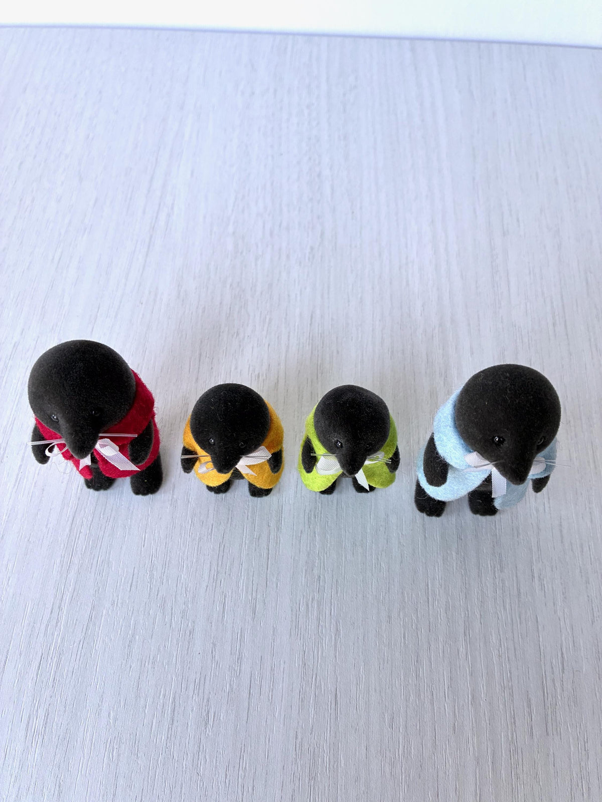 Calico Critters Sylvanian Families vintage McBurrows mole family, high angle view of all four in their felt capes