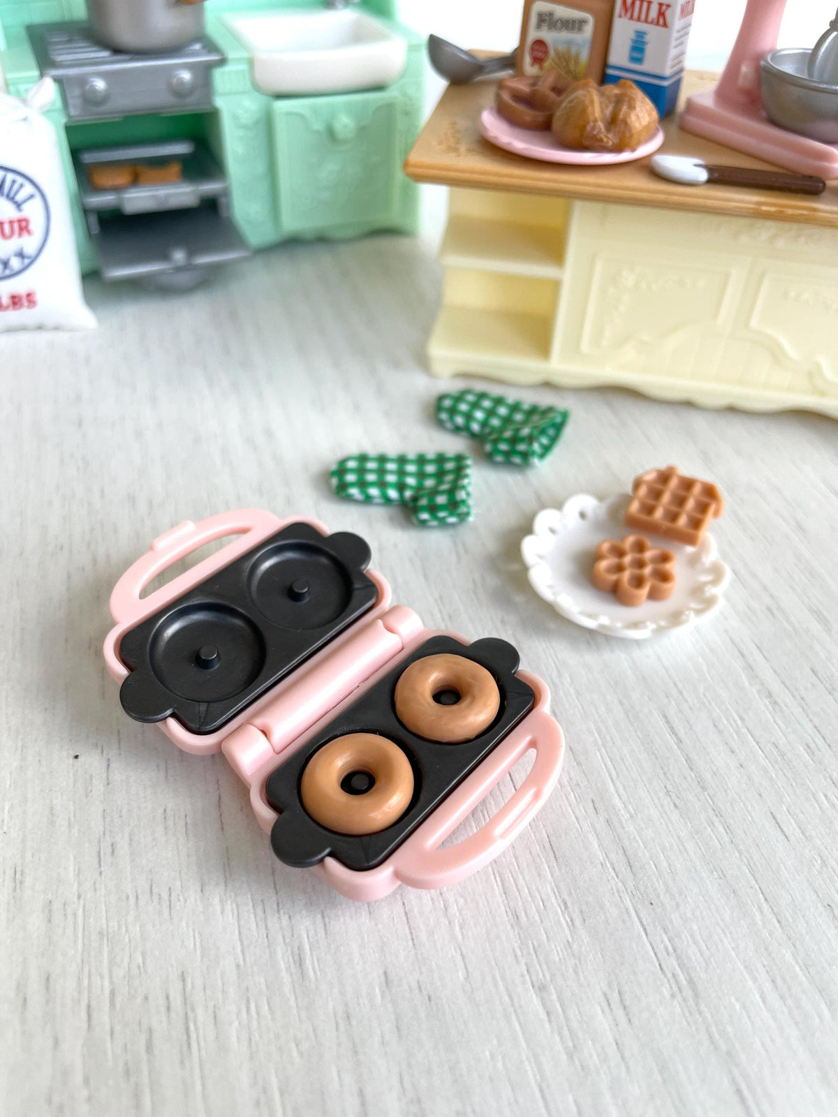 Pink waffle iron open with two donuts, plus waffles on a lace plate — Calico Critters and Sylvanian Families