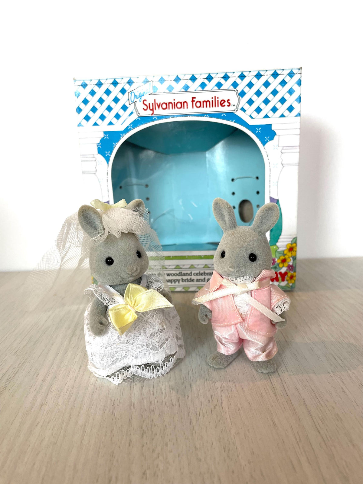 Vintage Tomy grey rabbit bride and groom standing together in front of their opened Sylvanian Families wedding box — Calico Critters and Sylvanian Families